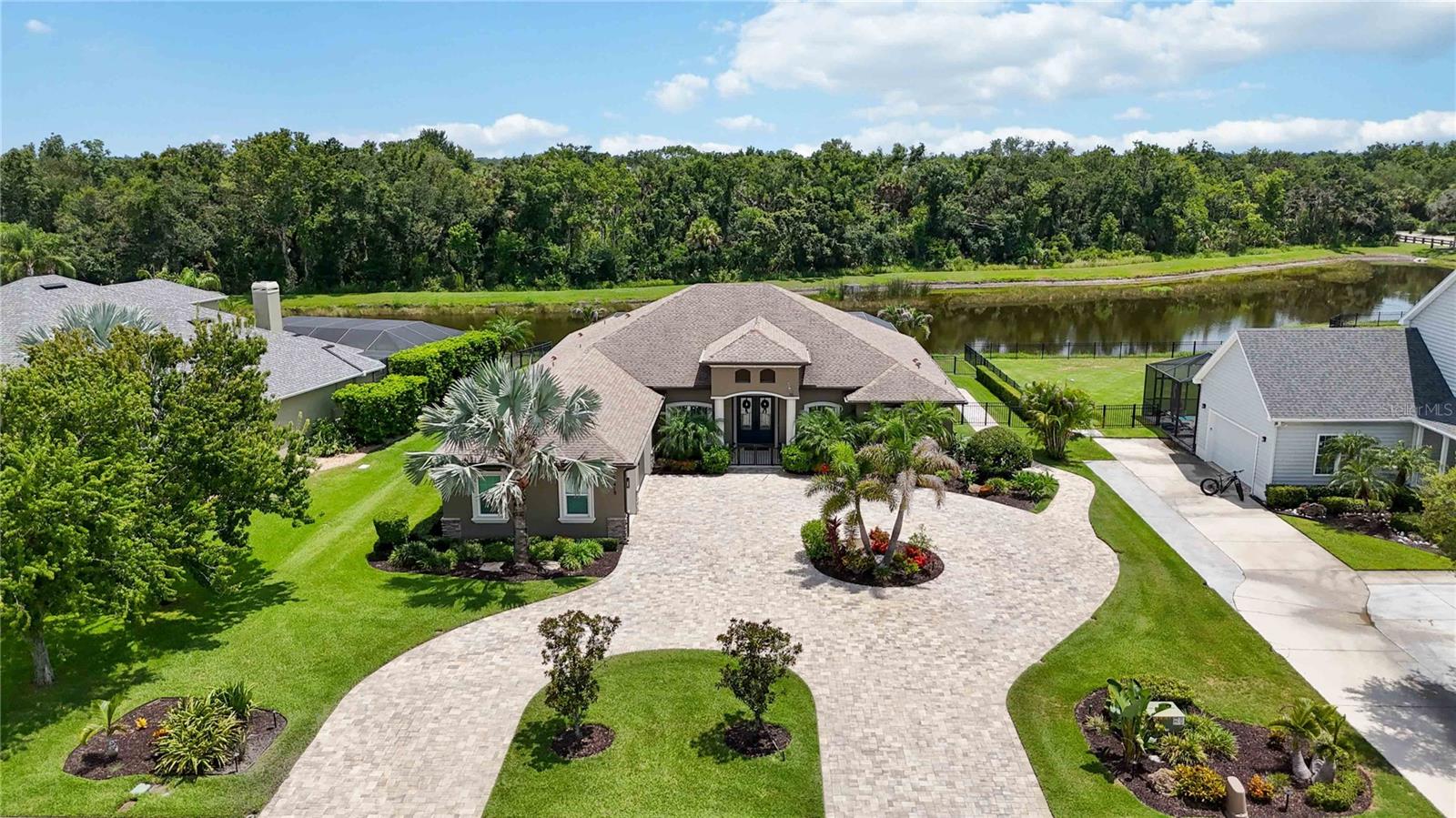 Welcome to Twin Rivers, one of Parrish’s most desirable communities, known for oversized homesites, custom homes, natural beauty, and a true sense of space. This exceptional custom-built pool home offers the privacy, flexibility, and outdoor living experience today’s buyers are seeking but rarely find.

Situated on a spacious homesite with peaceful pond views and no neighbors behind you, this residence provides a private backyard retreat designed for relaxation and entertaining. The open-concept floor plan seamlessly connects the indoor living spaces with the outdoors through expansive sliding glass doors, allowing the great room to flow effortlessly to the pool and covered lanai.

The beautifully designed kitchen is perfect for both everyday living and entertaining, featuring (2025) upgrades including a stylish backsplash, pot filler, reverse osmosis water treatment system, and brand-new dishwasher. The dedicated home office with double French doors offers a quiet and functional workspace, while the versatile media room provides the perfect setting for movie nights, watching the big game, or relaxing with family and friends.

Enjoy your private pool oasis with upgraded electric lanai shades, a pool heater added in (2025) with remote-control functionality, and an updated pool and lanai lighting package creating the perfect atmosphere for evening gatherings and enjoying the Florida lifestyle.

Additional features include an air-conditioned garage, generator wiring for added peace of mind, an attic lift installed in (2023) for convenient storage access, and a new HVAC system installed in (2025).

Twin Rivers offers a lifestyle unlike any other, with estate-style homesites, community river access, boat ramp, fishing areas, parks, playgrounds, and a welcoming neighborhood atmosphere with events throughout the year. This rare opportunity combines space, privacy, outdoor living, and modern comforts in one of Parrish’s most sought-after communities.