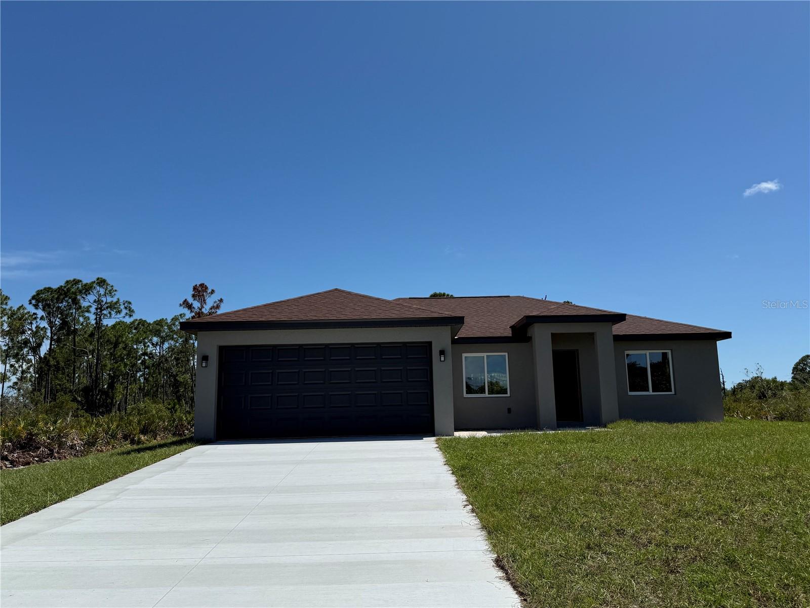 NEW CONSTRUCTION • MOVE-IN READY • PRIVATE WOODED SETTING
Welcome to 12233 Wagner Lane, Port Charlotte,  your brand-new Florida dream home! Nestled on a spacious homesite with peaceful wooded views.  This beautifully crafted 3-bedroom, 2-bath residence offers the perfect blend of modern design, quality construction and everyday comfort.  From the moment you arrive, you’ll appreciate the home’s clean architectural lines, attractive curb appeal, oversized driveway, and inviting covered entry. Inside, an open-concept floor plan creates a bright and airy living space designed for today’s lifestyle.
The stylish kitchen serves as the heart of the home and features, spacious center island with breakfast bar seating, soft-close cabinetry with modern finishes and fixtures,  open flow to the dining and living areas.  This home is perfect setup for entertaining family and friends.
The spacious owner’s suite provides a relaxing retreat with elegant tray ceiling, large walk-in closet, beautiful ensuite bath, oversized glass-enclosed walk-in shower, contemporary dual-sink vanity.
Two additional guest bedrooms offer flexibility for family, visitors, or a home office, while the guest bath showcases attractive floor-to-ceiling tile surrounding the tub/shower combination. This home comes with durable tile flooring throughout the entire home, volume ceilings for an open feel with ceiling fans already installed, recessed lighting,  covered lanai for outdoor enjoyment, indoor laundry room off from kitchen,  two-car garage.  Impactful modern color palette and finishes.
Step outside and enjoy the privacy of your backyard with natural Florida surroundings—providing a peaceful backdrop for morning coffee, evening sunsets, or future outdoor living enhancements. Conveniently located near Gulf beaches, boating, golf courses, shopping, dining, parks, and all that Southwest Florida has to offer, this home delivers exceptional value in a rapidly growing area. Why wait to build when you can move right into brand-new construction! Whether you're searching for your primary residence, seasonal retreat or investment property, this stunning new construction home is an opportunity you won't want to miss. Estimated completion mid to late June 2026. Secure this home now before it's finished and take advantage of owning a brand-new construction and energy efficient home. 
Buyer and buyers agent to verify all measurements. Please submit offer on AS IS contract. Please use showing time for showings. The data included in the MLS is deemed reliable but is not guaranteed. Buyers and their agents should verify all information or retain appropriate professionals. Taxes are reflected for land only.
Schedule your private showing today and experience the quality, comfort, and lifestyle that 12233 Wagner Lane has to offer!!!