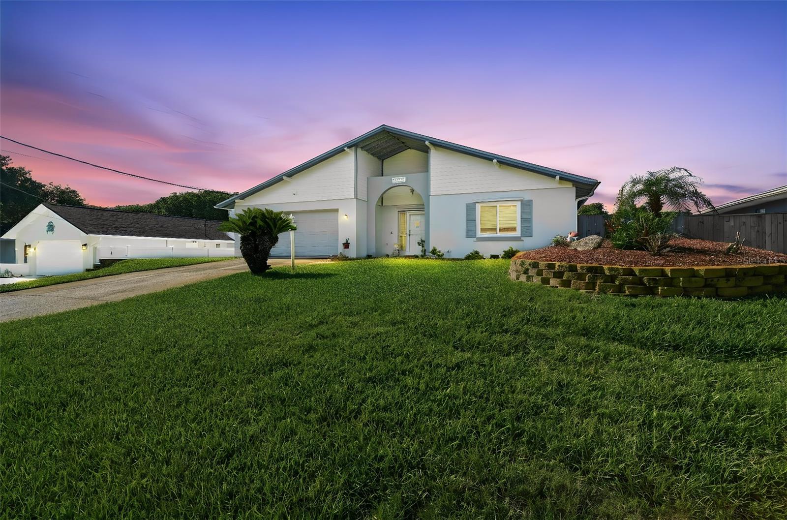 Welcome to 82 Jennifer Circle, a beautifully updated pool home in the highly sought-after coastal community of Ponce Inlet, known for its pristine no-drive beaches, world-famous lighthouse, boating, fishing, waterfront dining, nature preserves, and relaxed Florida lifestyle. Step inside to an open and inviting floor plan highlighted by exposed wood beam ceilings in the main living area and seamless spaces for gathering, entertaining, and everyday living. The fully renovated kitchen, completed in 2019, serves as the heart of the home with elegant quartz countertops, soft-close cabinetry, abundant storage, and excellent flow to both the dining and living areas. Just beyond the main living space, the Florida room offers exceptional flexibility as a sunroom, home office, hobby room, or additional lounge area, with a dedicated mini-split system to keep the space comfortable year-round while enjoying views of the backyard and pool. The generous floor plan provides privacy for everyone, featuring a spacious primary suite with updated flooring, a stylish barn door entry to the beautifully remodeled ensuite bath with dual vanity areas and a walk-in shower, plus additional generously sized bedrooms with updated flooring for family, guests, or work-from-home needs. Conveniently located near the oversized two-car garage is a half bath, perfect for rinsing off after a day at the beach or enjoying time by the pool, and the garage also includes a smart garage door opener for added convenience. Step outside to your private backyard retreat where a fiberglass pool is surrounded by a large attractive paver deck and fully fenced yard, with mature landscaping that includes pineapple and orange trees, irrigation supplied by well, and room for a garden. Whether hosting friends, enjoying family time, or relaxing in the Florida sunshine, this outdoor space is designed for year-round enjoyment. Additional improvements include updated windows in 2019, a completely new HVAC system in 2025, a 2022 roof, electrical updates throughout the home, refinished ceilings, and numerous thoughtful upgrades that make this property truly move-in ready, plus a spacious driveway and reinforced side parking with retaining wall designed to accommodate a boat. Located just minutes from the beach, Lighthouse Point Park, marinas, waterfront restaurants, and all the outdoor recreation Ponce Inlet is known for, this exceptional home combines modern updates, coastal charm, and the Florida lifestyle you’ve been dreaming about.