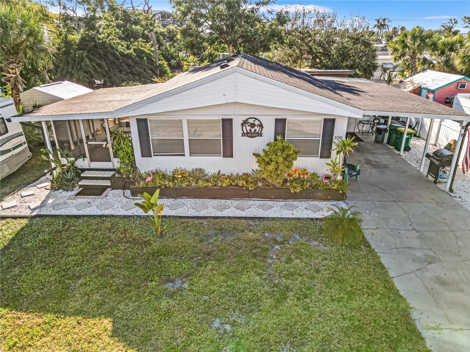 YOU WON’T BELIEVE THIS IS A MANUFACTURED HOME! Prepare to be amazed by this masterfully renovated coastal sanctuary on OWNED LAND—no lot rent! Sold turn-key and fully furnished, this home feels like a luxury custom build with a bright, open-concept design and designer finishes. Located just 1 block from the Intracoastal and 100ft from Stump Pass Marina/Lighthouse Grill, it’s a boater’s dream. Enjoy dry boat storage nearby and be on the Gulf in under 5 mins. The outdoor oasis features a private Tiki Hut, a large screened porch, and 2 storage sheds for all your gear, plus a 220V hook-up for a camper/RV. UNBEATABLE LOCATION: Walk to shops and dining, or take a short drive to Manasota Key and Boca Grande. Short-term rentals are allowed, making this a perfect primary residence, vacation getaway, or high-income investment. Every detail has been attended to in this high-end renovation. Truly a must-see to appreciate the quality. Schedule your showing today and start living the Florida dream!