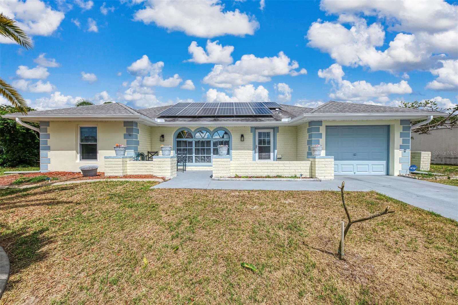 WATERFRONT POOL HOME WITH GULF ACCESS UNDER $300,000! This bright and inviting property offers a rare chance to enjoy Florida waterfront living with added energy savings. The home includes a SOLAR SYSTEM that is already installed and INCLUDED IN THE PRICE! The current owner pays a very small electric fee to Florida Power & Light, typically under $30 per month. Major updates provide peace of mind, including a newer roof that is approximately 4–5 years old, a newer A/C system, and a newer hot water heater. The refrigerator is only one year old. Impact windows and doors are installed throughout most of the home, with the exception of the front window and front door. Inside, the home has been freshly painted and features a comfortable layout designed for everyday living. A bright living room flows into a dining area, creating a welcoming space for relaxing or entertaining. The cozy kitchen overlooks the family room, allowing the cook to stay connected with the rest of the home. Natural light fills the space and highlights the clean, well-kept interior. The primary bedroom features brand-new laminate flooring and a large walk-in closet for plenty of storage. The primary bathroom includes a walk-in shower. The guest bathroom offers a tub and shower combination. The second bedroom is oversized and could easily serve as a second primary suite thanks to its generous size. Step outside and enjoy the Florida lifestyle from the covered lanai overlooking the pool and peaceful canal. The pool cage and lanai are newer, creating a great space to relax outdoors. The sparkling blue canal in the backyard adds a beautiful view and opens the door to endless water activities. Fish from your backyard, launch a small boat, or simply sit back and enjoy the calm water and wildlife. The canal leads to the Myakka River, then out to Charlotte Harbor and the Gulf of America, giving you true Gulf access right from your property. The home is connected to public water and sewer and is conveniently located near churches, schools, Lowe’s, Home Depot, restaurants, and the Atlanta Braves spring training stadium. Gulf beaches are only about a 20-minute drive away, making it easy to enjoy sand, sun, and coastal views whenever you like. This waterfront pool home offers location, upgrades, and boating access all in one property. Schedule your private showing today!