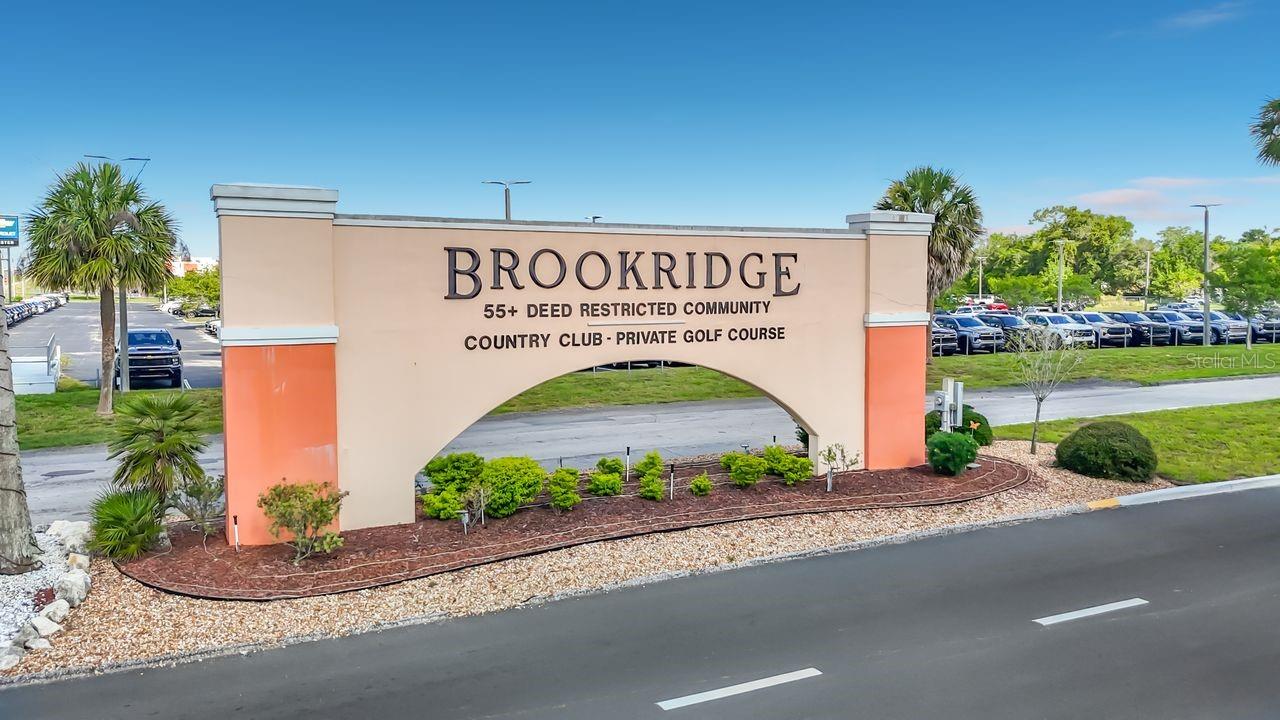 Located in the deed-restricted, guard-gated Brookridge 55+ golf course community, this property offers land ownership with a monthly HOA fee of $55.00 monthly. The home features a functional layout with a bright living area, an eat-in kitchen, and a split-bedroom design for privacy. The primary bedroom includes a walk-in closet and an en-suite bath. A screened porch provides additional outdoor living space, and the low-maintenance yard supports easy upkeep.

Brookridge is a golf-cart-friendly community with a clubhouse, pool, fitness facilities, activities, and 24-hour staffed gate access. Entry is controlled, and visitors may enter only when their name is placed on the approved visitor list. Conveniently located near shopping, medical facilities, dining, and the Suncoast Parkway.