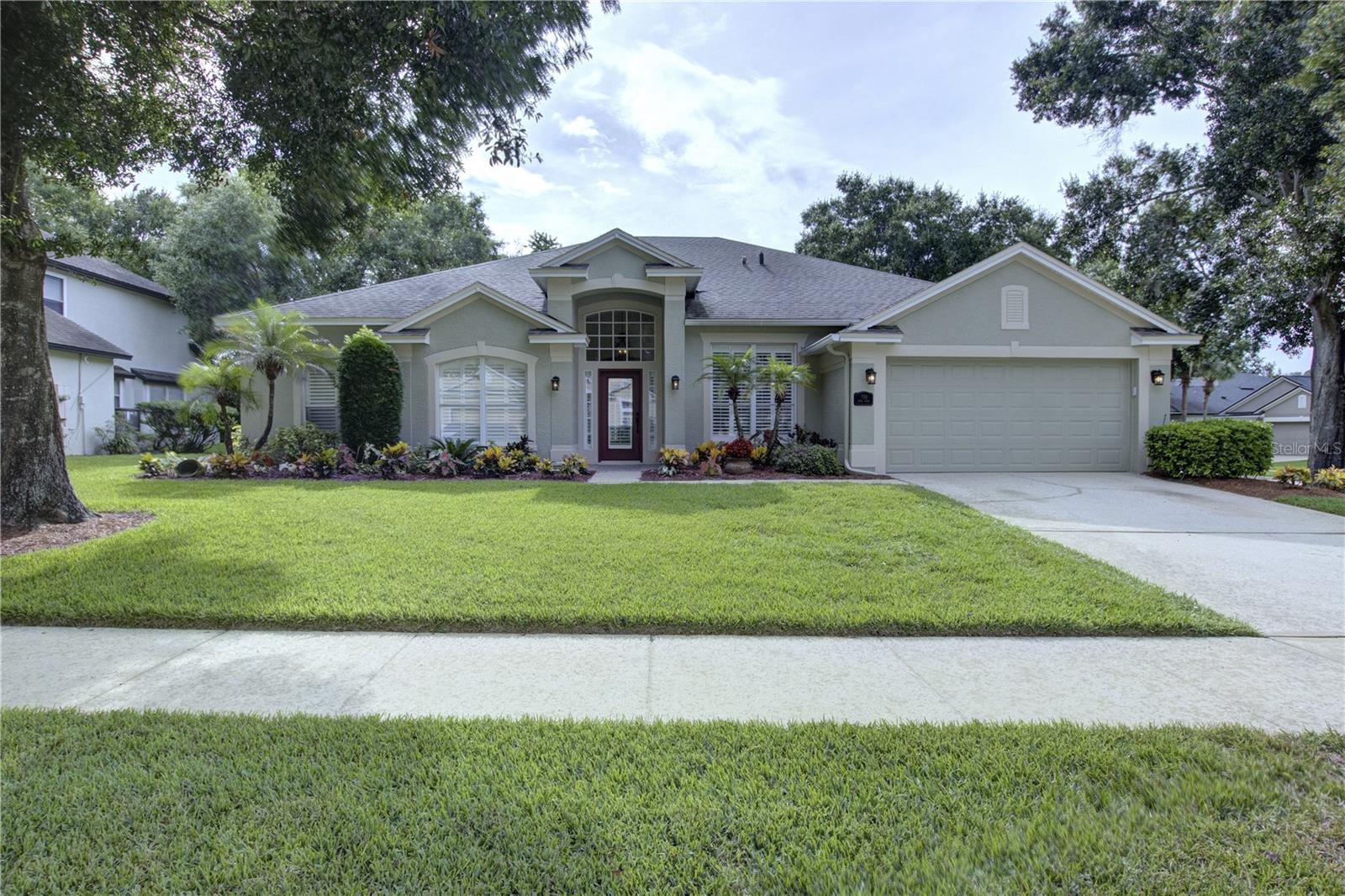 Welcome to this beautifully maintained 4-bedroom, 3-bath David Weekley pool home in the highly sought-after Timacuan Golf community. Featuring a spacious open-concept floor plan with a desirable three-way split bedroom layout, this home offers the perfect blend of comfort, privacy, and functionality. Double front entry doors welcome you into a bright, inviting interior designed for both everyday living and entertaining. The well-appointed kitchen features stainless steel appliances, abundant cabinetry, generous counter space, and an oversized breakfast bar that opens seamlessly to the living and dining areas. The spacious owner's suite serves as a private retreat with double vanities, a garden tub, and a separate walk-in shower with a seamless glass enclosure. Two secondary bedrooms share a Jack-and-Jill bathroom, while a third full bath with a walk-in shower provides convenient access for guests and the pool. Step outside through the French doors to your private Florida oasis. The oversized covered lanai overlooks a screened pool with a built-in spa, creating the perfect space for outdoor dining, entertaining, or simply relaxing year-round. Plantation shutters throughout and fresh interior and exterior paint add to the home's move-in-ready appeal. Timacuan is one of Lake Mary's premier golf course communities, known for its mature landscaping, scenic lakes, and optional memberships at The Links of Lake Mary. Ideally located just minutes from I-4, SR 417, Lake Mary Boulevard, Orlando Health Lake Mary Hospital, shopping, dining, and top-rated Seminole County schools, this exceptional home offers the perfect combination of location, convenience, and Florida living.