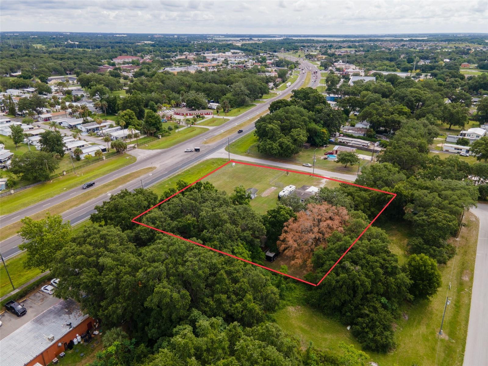 GREAT LOCATION AND GREAT BUSINESS OPPORTUNITY ON THE CORNER OF SOUTH ORANGE BLOSSOM TRAIL AND ORANGE LANE. Located on busy Highway 17-92 (S. OBT/S. John Young Parkway) just west of Pleasant Hill Road, this site is prime for development. Major development in the area from major fast food restaurants, car washes, banks, shopping centers, gas stations. Residential development continues to grow rapidly in the area too, only adding to the already high traffic exposure.