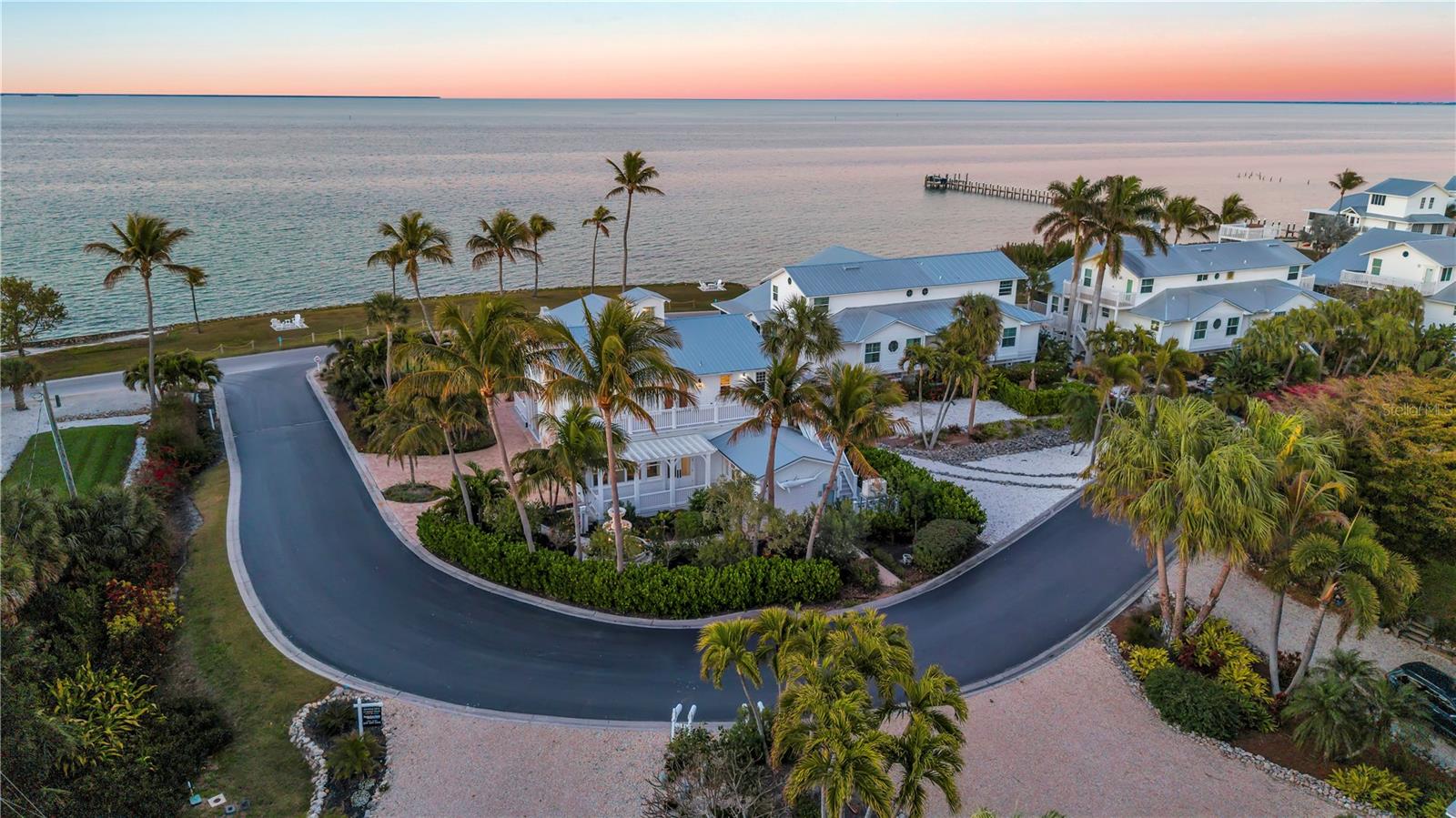 Formerly known as the iconic Bokeelia Tarpon Inn featuring 4 bedrooms, 5 bathrooms and may be purchased TURN-KEY. This historic estate blends early 1900s character with over $1 MILLION in high-end upgrades. PLUS, This home qualifies for 100% Bonus Depreciation on FF&E values!! Located on the northern tip of Pine Island, where the views simply do not get better. Enjoy water views from nearly every window in the home. Primary has Panoramic Views of Charlotte Harbor!  With 2 BOAT SLIPS and lift access, you’ll have quick and easy entry into Charlotte Harbor, Matlacha Pass, and the Gulf. Stepping into the home, the grand front entrance offers a massive covered sitting space, a perfect place to soak in the sunshine, coastal breezes, and peaceful waterfront scenery. Vintage charm greets you at every turn, beautifully preserved and enhanced with thoughtful modern updates. Natural light fills the home, creating a bright and airy feel throughout. The gourmet kitchen is a true showpiece, featuring a Big Chill refrigerator and gas range with unlacquered brass hardware, a designer industrial Zephyr ventilation hood, and a brass pot filler for added convenience. Brick flooring is laid in a classic herringbone pattern, while dramatic soapstone countertops elevate the space. The open-concept living area showcases porcelain tile flooring and a stunning touchstone built-in electric fireplace. Just off the main living area, the laundry room adds convenience. Enjoy garden views from the only downstairs guest bedroom. Upstairs, solid wood flooring and custom hardwood stair treads maintain the home’s historic integrity. You will find the expansive primary suite features vaulted ceilings and a cozy revolution, built-in electric fireplace. The spa-inspired primary bath offers water jet-cut marble mosaic tile on the vanity wall, shower inset, and shower floor, a freestanding soaking tub with a Kingston Brass floor-mounted tub filler and hand shower, and custom solid wood cabinetry beneath quartz countertops. Additional Features include: 2 A/C units, spray foam insulation, a walkable attic with additional storage, a high-efficiency tankless water heater, a permanently installed Generac standby generator, a HOOT aerobic septic system, ELECTRIC HURRICANE protection, and Kevlar protection for the upstairs lanai. The exterior is equally impressive with James Hardie shake siding, all-new Azek decking, railings, and stairs, and a custom-built pergola with electric. The oversized lot is beautifully landscaped with mature fruit trees along with a coral fountain surrounded by a rose garden. You are just minutes from world-class boating and fishing destinations including Boca Grande Pass and Cayo Costa. You’re also close to the Bokeelia Fishing Pier, charming island dining, Pine Island Center, and everything that makes Pine Island such a peaceful and desirable coastal community. With breathtaking water views, historic significance, luxury finishes, and unmatched zoning flexibility, this is truly a one-of-a-kind investment and lifestyle opportunity.