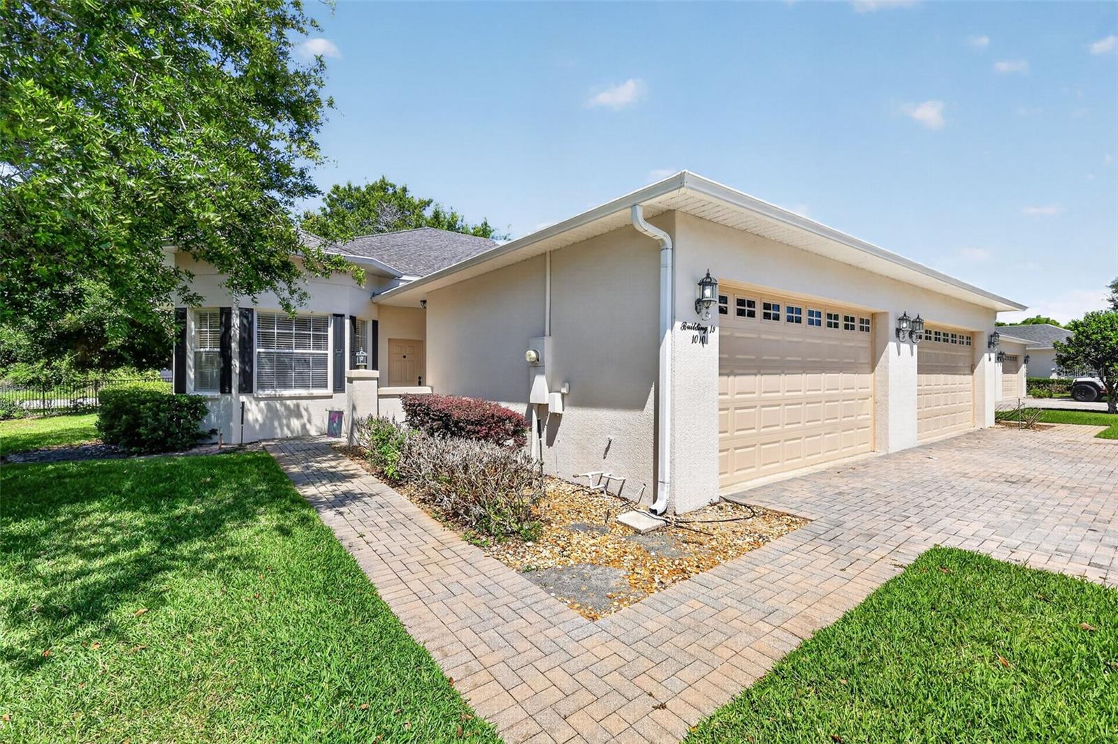 One or more photo(s) has been virtually staged. Welcome to EASY LIVING in a GATED CLERMONT COMMUNITY, nearby CLERMONT'S CHAIN OF LAKES. This ORIGINAL-OWNER, WELL-MAINTAINED 3BR/2BA VILLA offers 1,320 SQ. FT., a 2-CAR GARAGE, and a SCREENED REAR PORCH OVERLOOKING THE NEIGHBORING GOLF COURSE with a peaceful oak-tree backdrop.

Inside, enjoy WOOD FLOORING in the main living area, an OPEN-CONCEPT LAYOUT, and a functional kitchen with WOOD CABINETRY, GRANITE COUNTERTOPS, BREAKFAST BAR, and a WALK-IN PANTRY WITH FLOOR-TO-CEILING SHELVING. The PRIMARY SUITE features TWO WALK-IN CLOSETS WITH FLOOR-TO-CEILING SHELVING and an EN SUITE BATH with PRIVATE WATER CLOSET, TILED SHOWER WITH BUILT-IN BENCH, and GLASS ENCLOSURE.

Additional features include a LAUNDRY ROOM WITH 2 ADDED CLOSETS AND STORAGE SHELVING, AUTOMATIC GARAGE OPENER, 2025 WATER HEATER, BRAND-NEW MICROWAVE AND DISHWASHER, and 2017 HVAC.

Enjoy outdoor living from the SCREENED REAR PORCH SURROUNDED BY OAKS and the PAVED COVERED FRONT PATIO WITH SEMI-PRIVATE WALL. HOA includes IRRIGATION WATER, CABLE AND INTERNET, LAWN CARE, and maintenance of the GATES, ROADS, and COMMUNITY POOL.

Community amenities include GATED ENTRY and COMMUNITY POOL. Located directly across from GREEN VALLEY COUNTRY CLUB featuring an 18-HOLE GOLF COURSE and ON-SITE DINING, and just minutes to the SOUTH LAKE BIKE TRAIL, DOWNTOWN CLERMONT, BREWERIES, FARMERS MARKETS, FESTIVALS, PARKS, WINERIES, PUBLIC BEACH ACCESS, HWY 50, THE FLORIDA TURNPIKE, and ORLANDO-AREA DESTINATIONS.

A great opportunity to enjoy CHAIN OF LAKES ACCESS in a gated Clermont community. Dock availability may be leased separately within the community, giving owners the opportunity to pursue their own private dock access and enjoy the boating lifestyle just steps from home.