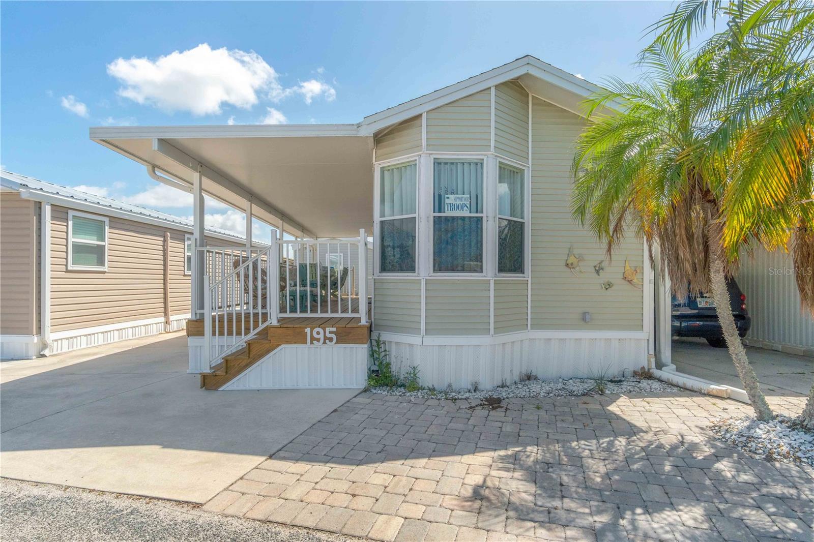 ENGLEWOOD DREAM VACATION GETAWAY—AND YOU OWN THE LAND (NO LEASE FEES)!
Welcome to this bright and inviting home in the friendly 55+ community of Holiday Travel Park, located in beautiful Englewood, FL. Situated on Avenue F, this home enjoys a prime location within the park—just steps from the clubhouse where many social events and activities take place.
This charming 1-bedroom, 1-bathroom home offers 408 square feet of thoughtfully designed living space and is just minutes from Englewood Beach. Major updates completed in 2023 include a new HVAC system, plumbing, and water heater, along with a roof replaced in August 2024 for added peace of mind.
Step inside this turnkey furnished retreat and immediately notice the abundance of natural light, enhanced by bright windows and vaulted ceilings that create an open, airy feel. The living area is tastefully decorated with a modern touch, perfect for relaxing or entertaining. The kitchen is equipped with a microwave, range/oven, refrigerator, and ample cabinet and counter space, making everyday living easy. Just off the kitchen, the dining area is surrounded by beautiful bay windows, offering a bright and welcoming space to enjoy meals.
Down the hall, you’ll find a well-lit bathroom featuring modern LVP flooring. The spacious bedroom includes a comfortable bed, bedside tables, a built-in dresser, and a generous closet. It also offers direct access to the outdoor covered deck.
Step outside to a stunning 35’ x 8’ newly stained wooden deck that spans the length of the home—perfect for morning coffee, evening relaxation, or entertaining guests. Stairs lead down to the yard, where you’ll find an 8’ x 3’ storage shed for tools or outdoor equipment.
Holiday Travel Park offers an array of amenities, including a sparkling swimming pool, shuffleboard courts, and even the only indoor pickleball court in Englewood. Residents enjoy a vibrant social calendar with organized events and activities, creating a true sense of community.
Located in the heart of Englewood, you’ll be just minutes from pristine beaches, charming local shops, art galleries, and fantastic dining options—especially fresh coastal seafood. Whether you’re looking for a seasonal retreat or a full-time residence, this home offers the perfect blend of relaxation, convenience, and coastal living.
Welcome home!