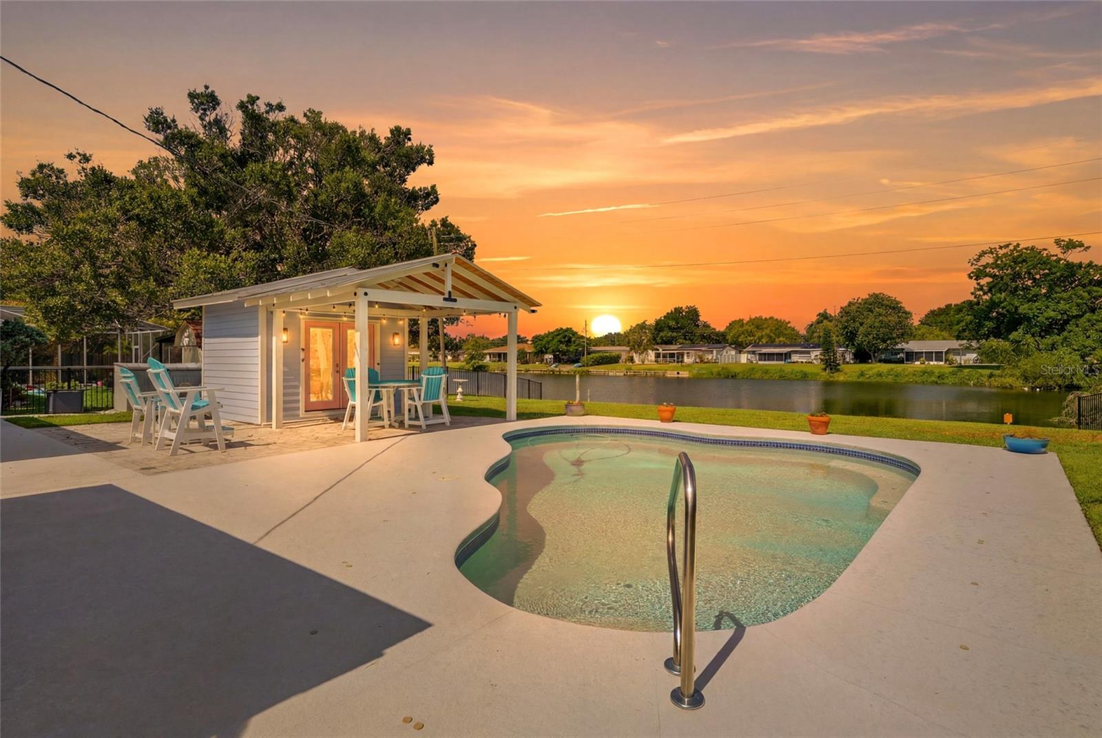 Completely renovated from top to bottom this stunning waterfront home in Kenneth City has been beautifully updated with quality finishes and major system upgrades, giving you true peace of mind. Features include hurricane-impact windows and doors, a new electrical panel, new water heater, water softener system, attached one-car garage, tile flooring throughout, marble countertops, and a bright open-concept floor plan. The home is also equipped with a 2014 roof and 2014 Trane HVAC system. The spacious primary suite feels like a private retreat with a massive bedroom and oversized walk-in shower with soaring 8-foot ceilings.
Then you step outside. With 71 feet of lake frontage, this backyard is unlike anything else you'll find in this price range. Relax in the screened lanai before taking a dip in the solar-heated saltwater pool, built in 2018, and then relax in the brand-new hot tub, and entertain under the resort-style poolside cabana featuring a pool side bar and built-in speakers. Whether you're hosting game day, family gatherings, or quiet evenings watching the sunset over the water, this is the kind of backyard you dream about. The lake is stocked with bass and other fish, while turtles, ducks and native birds create a peaceful setting you'll enjoy every day. Beyond the property, Kenneth City offers a true sense of community with its own police department, a newly renovated park featuring a splash pad, basketball and pickleball courts, and a community center available to residents for parties, events, and gatherings. Homes with this level of renovation, a resort-style backyard, and waterfront living rarely hit the market, call today for a private showing.