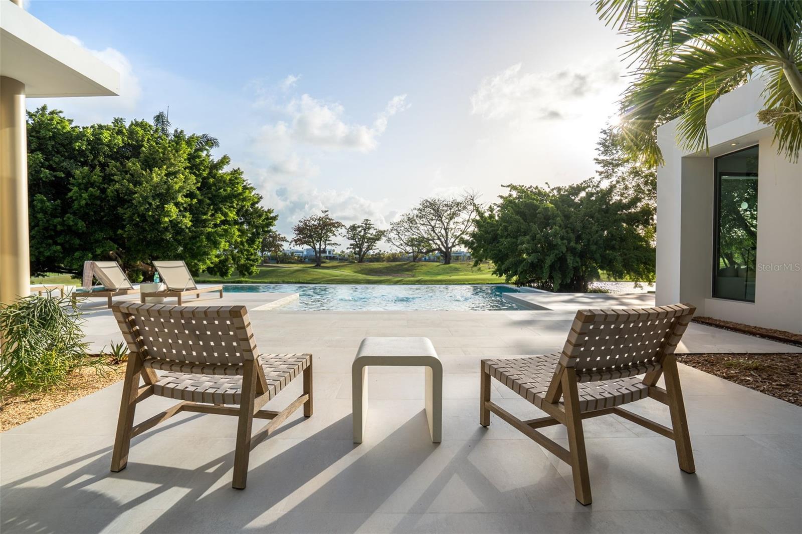 Every evening at Malibu Vista, the sun sets directly over your infinity pool, your golf course, and your lake — turning the entire back of this interior designer-curated estate into the most breathtaking scene in all of Dorado Beach. Properties that capture both golf course and western-facing sunset views here are extraordinarily rare — and one finished to this level is rarer still. Completely reimagined and redesigned from the inside out — every inch, every finish, every detail — to a standard that sets a new benchmark for luxury in Dorado Beach. The result is 5,172 AC sq ft of meticulously crafted living space within a total footprint of over 7,646 covered sq ft, all set on a sprawling 2,477 square meter (0.61 acre) lot. Soaring ceiling heights and an abundance of natural light pour through an open floorplan designed for seamless indoor-outdoor living. Outside, a fully equipped outdoor kitchen and dedicated outdoor living room extend the experience — where the Caribbean breeze is your air conditioning and the golf course is your wallpaper. Five bedrooms with walk-in closets. Five and a half resort-caliber baths. The views don't stop at one room or one wing — at Malibu Vista, the golf course and infinity pool are your backdrop whether you're cooking in the kitchen, relaxing in the living room, unwinding in the junior suite, or waking up in the primary bedroom and bath. This home was designed so that the best view in the house is wherever you happen to be standing. Two full laundry rooms. Full designer appliances including wine refrigerator, built-in oven, and range hood — all brand new. A Dorado Beach Membership is available for purchase, unlocking world-class golf, beach club, and resort amenities.