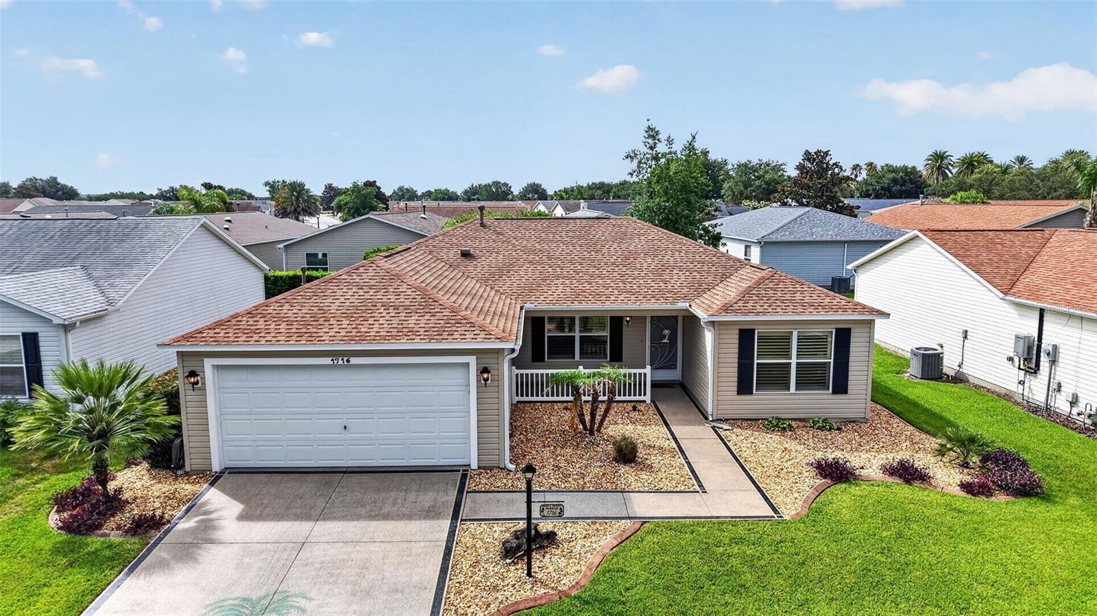 LOCATION LOCATION! Located off Bailey Trail, this beautiful Amarillo model offers a great combination of updates and value with the BOND PAID! Prime location between 466 and 466A near Lake Sumter Landing! VILLAGE OF SUNSET POINTE! NO CARPET! This popular split floorplan could be your Florida retreat.  You will notice the beautiful curb appeal and inviting front porch. As you enter the home the vaulted ceilings opens up the space! The living room, dining room, and kitchen combo allows for great entertaining of family and friends. PLANTATION SHUTTERS throughout the house. The kitchen has stainless steel appliances and beautiful backsplash. The guest wing is tucked behind a pocket door and features  two bedrooms and a bathroom.  The primary suite has dual closets, dual sinks, a water closet, and walk in shower! The shower was just redone in June 2026!  Through the sliding glass door you enter in tiled lanai with acrylic windows for additional space! The garage features EXPOXY FLOORING! Major improvements include a 2023 ROOF  and an AC system approximately 5 years old, providing peace of mind. The home also features a tankless hot water heater, a 2024 refrigerator, and a new microwave installed in 2025. This well-maintained home is move-in ready and ideally located for convenience and lifestyle. Only one owner!