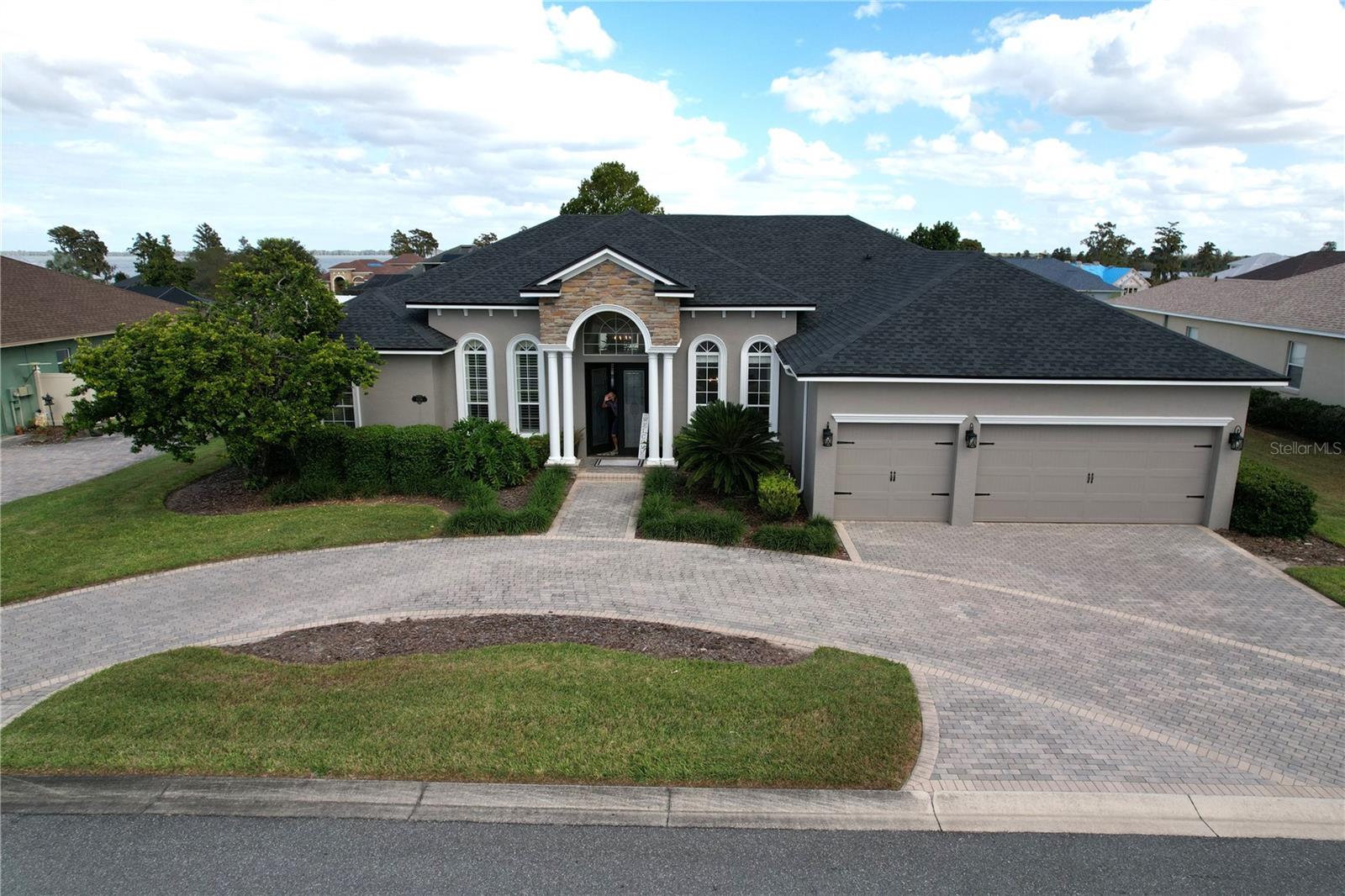 This Hulbert-built home, recognized as the Polk County Builders Association's 2006 Home of the Year, offers recent upgrades. In 2022, the roof and exterior paint were updated. The AC system was upgraded in 2018, and a new water heater was added in 2023. The home is in the gated River Lake community with access to amenities like Pickle ball & tennis courts and a recreation building overlooking Lake Hancock. Inside you'll find an open floor plan features include a dining room with a new wood plank ceiling, a large great room with French doors to a screened pool and a fenced backyard. The kitchen includes new black stainless steel appliances, a center island, a breakfast nook, a built-in desk, and a pantry closet. The house has a three-way split bedroom layout  All bedrooms have walk-in closets. The spacious master bedroom and en suite bathroom offer dual sink vanity, corner soaking tub, and a walk-in shower. Other features include new wood look tile flooring thorough main living area, LVP in bedrooms (no carpeting), ceilings range from 10 to 14 feet, a bonus room/fifth bedroom, a well-equipped laundry room, and a built-in speaker system. The house also has a pest defense system,  a site built block utility shed, and an irrigation well or public water connection. Pool cage was rescreened in 2017 and new pool pump installed in 2020, 3-car garage and brick-paved circular driveway. This home offers quality and convenience. It's an excellent opportunity for those seeking an upgraded residence. Don't forget to explore the Matterport virtual tour.