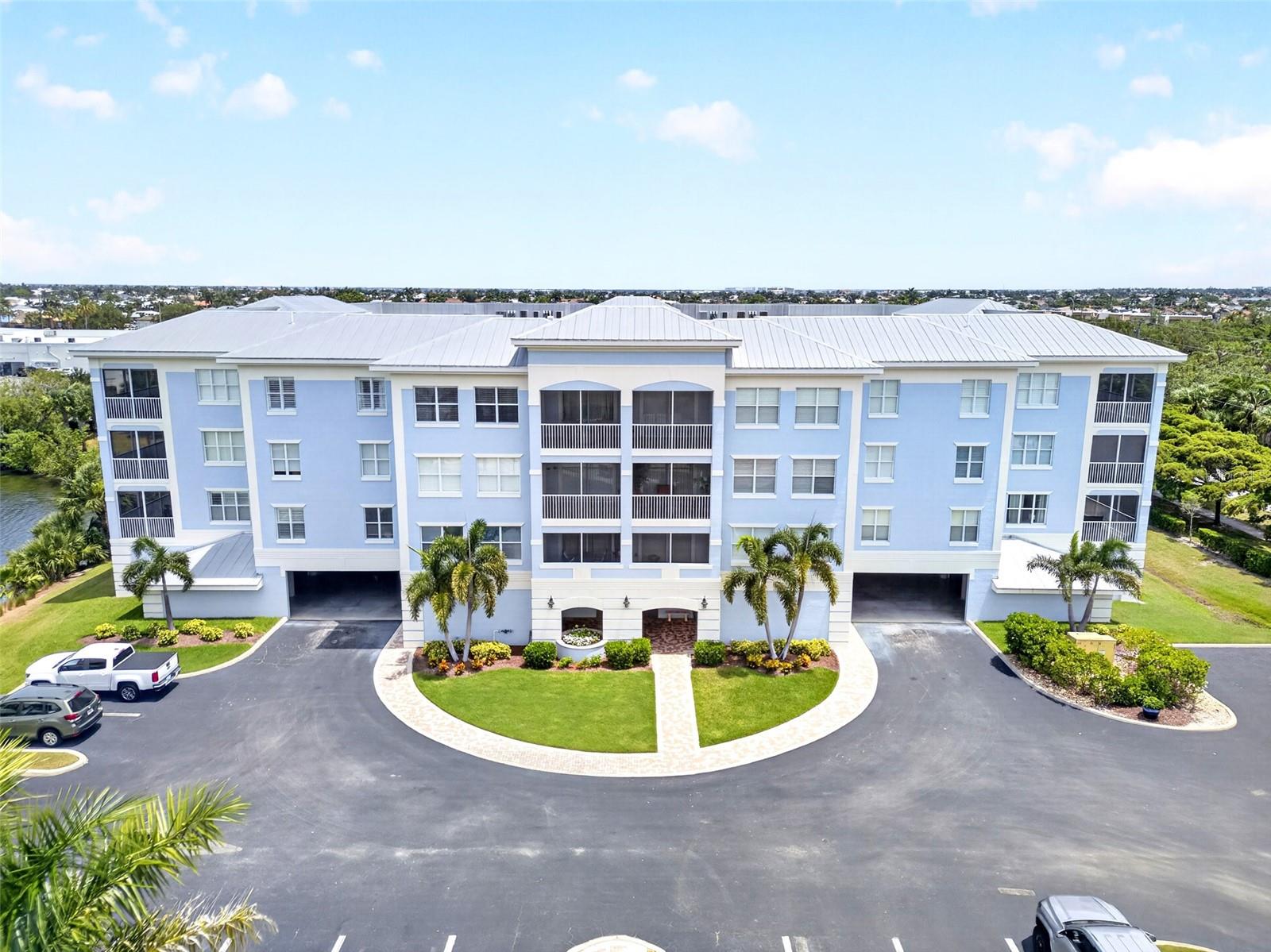 THE PRESERVE AT BAL HARBOR! TOP FLOOR 3 BEDROOM, 2 BATH END-UNIT WITH COVERED PARKING. Split floor plan includes 1,768 square feet of living space, featuring high ceilings, plantation shutters, and water views. This end-unit layout is all about natural light since you have extra windows and a large sliding glass door in the living room. The transition from the living room to the dining space is seamless, creating a perfect flow for hosting and entertaining. The kitchen has wood cabinetry, granite countertops, tile backsplash, stainless appliances and breakfast bar. Generous primary bedroom offers a tray ceiling, access to the lanai, large walk-in closet and private ensuite bath with dual sinks, a soaking tub and walk-in shower. Split floor plan ensures ultimate privacy for guests with two additional bedrooms that share a well-appointed guest bath. Additional notable features include a building elevator, gated access, assigned covered parking under building, 10'x10' storage unit by parking space, outside guest parking and beautiful courtyard entry. Located in a friendly waterfront community in Punta Gorda Isles with resort-style amenities including clubhouse, billiards, large pool, fitness room and private lake with pier to enjoy fishing and beautiful sunsets. Just a short distance to St. Andrews South Golf Club, Fishermen’s Village, downtown historic Punta Gorda with restaurants, shopping, entertainment and community events. Don’t miss this opportunity! Call for your private showing today!