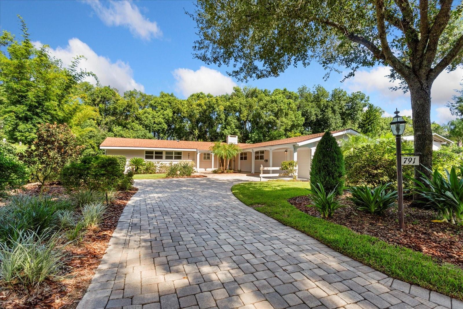 Discover a rare opportunity in Dommerich Woods, a distinguished and established Maitland neighborhood celebrated for its rich heritage. Situated on .33 acre of lushly landscaped grounds, this remarkable property welcomes with paver drive and enjoys a tranquil setting along a
peaceful creek connecting Lake Minnehaha and Lake of the Woods - creating an atmosphere of natural elegance and privacy.
Re-roofed in 2023, this expansive 5 bedroom, 3 1/2 bath residence offers 4,144 HSF, and WHOLE HOUSE WATER SOFTNER, showcases a versatile TWO-LEVEL design, perfectly suited for refined living and gracious entertaining. The main level opens with a foyer leading into a bright, open living and dining area, where CEILING FANS throughout the main level add comfort and elegance. From here, step out onto the COVERED UPPER DECK with sweeping views of the SCREENED POOL, TROPICAL GARDEN, and serene backyard retreat - an ideal setting for morning coffee or evening gatherings.
At the heart of the home, the GOURMET KITCHEN blends style and functionality with SOLID WOOD CABINETRY, a built-in WINE REFRIGERATOR and WINE RACK, granite countertops, and a CENTER ISLAND with SEATING, and REVERSE OSMOSIS WATER SYSTEM under the DOUBLE SINK. The adjacent laundry room offers exceptional storage, keeping household essentials organized. For added convenience , a two-car garage with built-in cabinets and workshop area, adjoins the spacious laundry room that has granite counters and washer and dryer. Also on the main level , adjacent to the primary bedroom with en-suite bath, a bedroom has been thoughtfully converted into a large closet featuring a CUSTOM CLOSET system, providing abundant space for wardrobe organization.
Both levels feature inviting WOOD-BURNING FIREPLACES that add ambiance to the living spaces. On the lower level, a spacious family room, kitchenette, study/library/office, two bedrooms, full bath and half bath provide the perfect complement to easy living. Along the
hallway, built-in wood shelving creates a refined showcase for books, art, or personal collections. While one bedroom includes a custom built 
in desk- ideal for work or study, a second bedroom adds flexibility for creative projects. This level opens onto the screened pool and patio area, designed for seamless indoor-outdoor living. Outside, tropical plantings, METERED IRRIGATION, and a winding private walkway leads along the soft murmur of the BORDERING CREEK. An added bonus is the storage room located below the kitchen which is approximately 375 sq.ft.  Whether hosting guests or enjoying a quiet evening, this private oasis offers the ultimate backdrop for relaxed Florida living.
Enjoy the opportunity to join the Dommerich Beach Civic Association with membership options including access to a private picnic area, boat ramp, canoe and kayak storage, and unforgettable evening sunsets. With its rare combination of design, flexible spaces, and an idyllic setting , this residence presents a unique opportunity to experience the very best of Maitland and Central Florida living. All this is convenient to some of Central Florida's finest schools, shopping, restaurants, parks, entertainment, businesses and more!