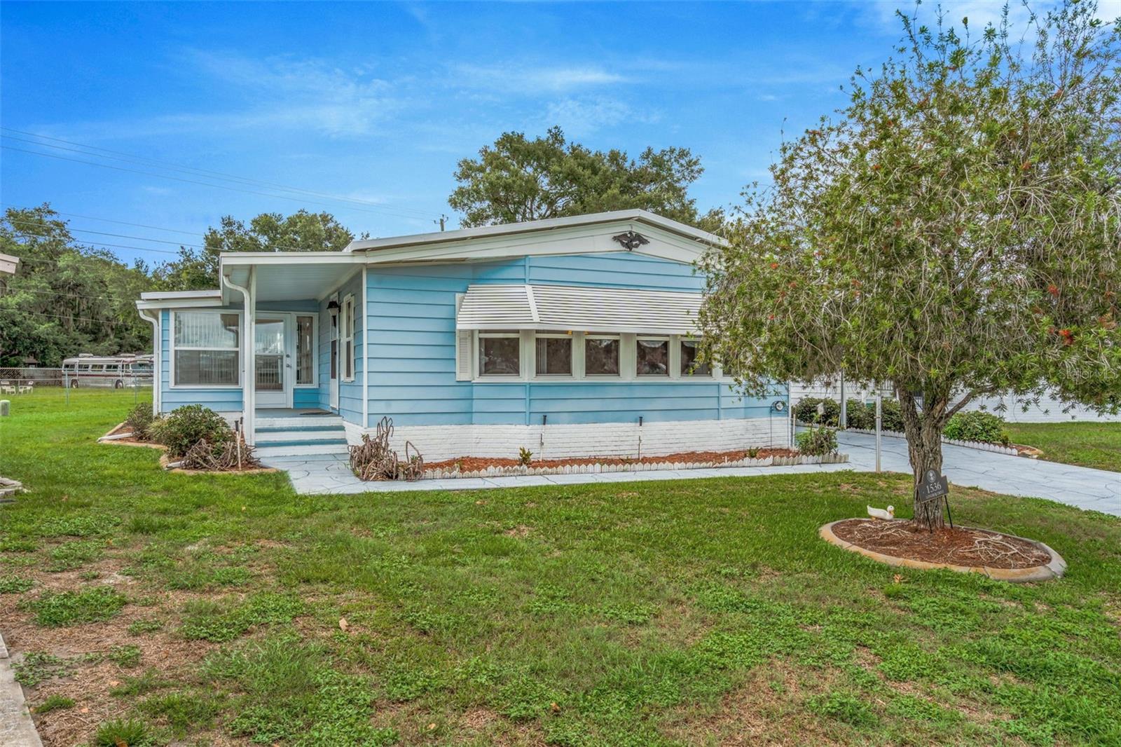 **Own the Land—No Lot Rent!** Welcome to carefree Florida living in this well-maintained **2-bedroom, 2-bath home** located in a desirable **55+ community** in Lakeland. Offering comfort, convenience, and an active lifestyle, this property is perfect for those looking to enjoy retirement or seasonal living without paying monthly lot rent.

Conveniently located just minutes from **Sam's Club**, shopping, restaurants, medical facilities, and a variety of retail destinations, you'll appreciate having everything you need nearby while enjoying the peaceful atmosphere of this welcoming community.

Inside, you'll find a comfortable floor plan featuring two spacious bedrooms, two full bathrooms, an **inside laundry/utility room**, and a **bright, enclosed bonus porch** that can serve as a sunroom, hobby room, home office, or the perfect spot to enjoy your morning coffee. The home also features a **wheelchair-accessible electric ramp**, providing added accessibility and ease of entry.

Step outside to a **spacious yard** complete with an **irrigation system**, offering room to garden, entertain, or simply enjoy the Florida sunshine.

Life here is about more than just the home—it's about the lifestyle. Residents enjoy outstanding amenities including a **heated swimming pool**, **sauna**, **fitness center**, **library**, **pickleball courts**, **shuffleboard**, a **scenic lake with a walking trail**, **golf cart-friendly streets**, a **clubhouse**, and **security patrol**.

The vibrant clubhouse is the heart of the community, hosting a full calendar of social activities including **weekly bingo, community breakfasts, coffee hours, flea markets, card games, live entertainment, seasonal events, and many other opportunities to meet neighbors and stay active**.

Whether you're searching for a full-time residence or a seasonal Florida getaway, this home offers the perfect blend of affordability, accessibility, convenience, and community.

**Best of all, you own the land—there's no lot lease to worry about.**

Come experience everything this wonderful home and community have to offer. **Schedule your private showing today and bring your offer—the seller is ready to welcome its next owner!**