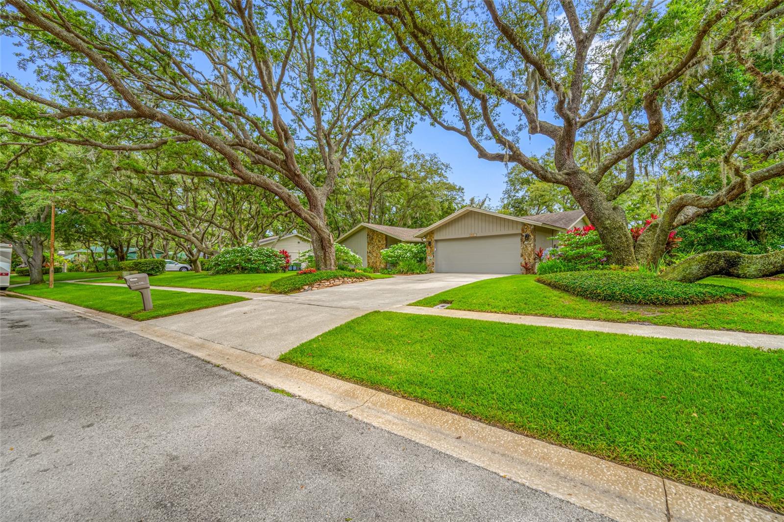 This is a Lovely home with a manicured lot of almost a half acre in a Beautiful, quiet, treed neighborhood. The home has had many upgrades including the roof in 2018, the AC and laundry room in 2019, Master Bath in 2020, Kitchen and hall bath were done in 2023, and the spacious screened porch was renovated and tiled in 2025.  Many other upgrades such as flooring, appliances, shutters on the windows, lighting etc. have also been done.  There are two bedrooms on each side of the home with formal living and dining rooms, as well as a dinette area and family room that is open to the kitchen. There is plenty of room for a pool if that is what your heart desires. The TV, surround system and all the equipment associated with this system, will remain with the house.  This is truly a special home on a special lot in a special neighborhood, just waiting for it's new special owners.