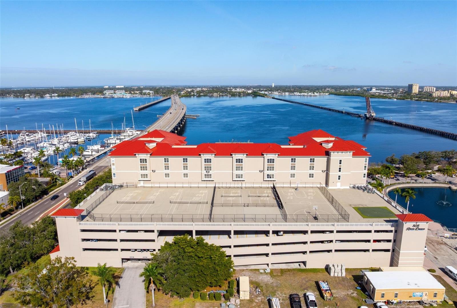 Welcome to this impeccable, completely remodeled riverfront residence, offering a partial view of the Manatee River and a polished, move-in-ready presentation. The unit has been thoughtfully updated throughout, including a renovated kitchen and baths, new flooring, updated fixtures, and refined finishes. High-impact windows enhance sound reduction and provide added protection. The interior layout offers efficient use of space with modern design elements and neutral finishes. This residence includes two deeded parking spaces and a climate-controlled storage cage, providing added convenience and secure storage.
The building is situated directly along the Bradenton Riverwalk, offering immediate access to paved waterfront paths ideal for walking and running, along with close proximity to downtown Bradenton dining, cultural venues, marinas, and public dock access. Community amenities include a clubhouse, fitness center, covered parking, swimming pool, and tennis courts. The community also provides two furnished guest suites that may be reserved for overnight visitors, adding flexibility when hosting. All the bells and whistles are here, making this property suitable for full-time living, seasonal use, or investment, subject to association regulations.