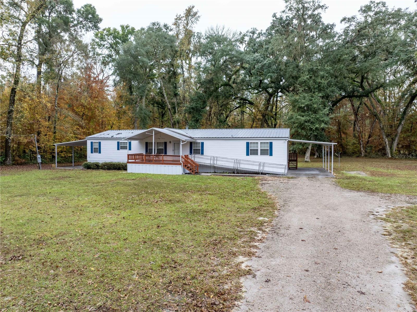 Three Rivers Estates home with GREAT FLOORPLAN: Spacious 4BR/2BA double-wide manufactured home on 1.84 acres in the highly sought-after Three Rivers Estates. This home an amazing floorplan with a large bonus room featuring a wet bar with full-size refrigerator, a cozy living room with gas fireplace, and a kitchen with breakfast nook. The owner’s suite includes a bathtub, separate shower, and double-sink vanity. Tile flooring in the kitchen and bathrooms, vinyl flooring in living areas, and carpet in bedrooms. Exterior features include a 20x24 covered front porch with handicap ramp, 1-car attached carport on one side, covered patio on the other, and a storage shed. Metal roof replaced in 2021; septic drainfield replaced in 2024. Seller provides a termite bond and home warranty for added peace of mind. Three Rivers Estates offers access to 7 parks parks and 2 boat ramps along the Ichetucknee and Santa Fe Rivers with a voluntary TREPO membership of $175/year. All of this is located near the beautiful and historic Suwannee River, Santa Fe River, Ichetucknee Springs, and numerous crystal-clear freshwater springs—an absolute dream for water lovers. Conveniently situated between the quaint towns of Fort White and Branford for everyday shopping and dining, and just a short 30-minute drive to Lake City or approximately 45 minutes to Gainesville. Schedule your showing today.