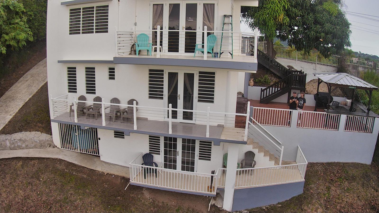 Mango Hill Retreat — Your Dream Rincón Investment Awaits
Perched on a lush hillside in the heart of Rincón, Puerto Rico's most celebrated surf town, Mango Hill Retreat is a stunning 3-story, 3-bedroom/2.5 -bathroom home offering panoramic 360-degree views and an already thriving Airbnb business — listed at $749,000.
From the moment you step through the gated entrance, flanked by towering mango trees that give this retreat its name, you know you've found something special. The property is set on a generous, beautifully maintained lot with mature tropical trees, open lawn areas, and multiple private decks on every level — perfect for morning coffee with ocean breezes or evening sunset gatherings. A covered outdoor lounge with a grill gazebo completes the ultimate Caribbean entertaining setup.
Inside, the home is thoughtfully finished with tile floors, mini-split A/C in every room, and light-filled interiors. Each floor opens to its own balcony or terrace, creating an effortless indoor-outdoor flow that guests rave about.
Location is everything here. You're less than 5 minutes from world-famous Domes Beach and Sandy Beach, Rincón's premier surf breaks that draw riders from around the globe. Steps Beach — beloved by snorkelers for its crystal-clear waters and marine reserve — is a short drive away, as is Playa Doña Lala, a favorite local hangout with vendors, volleyball, and jaw-dropping sunsets. The Rincón Surf School & Resort is practically in your backyard for lessons and rentals, and Rincón's charming town square with its restaurants, bars, and shops is just minutes away.
With a security camera system already installed, an established Airbnb brand, and consistent rental income potential in one of Puerto Rico's hottest tourism destinations, this property is as turnkey as it gets. Whether you're looking for a personal retreat, a vacation home, or a high-performing short-term rental, Mango Hill is the one.