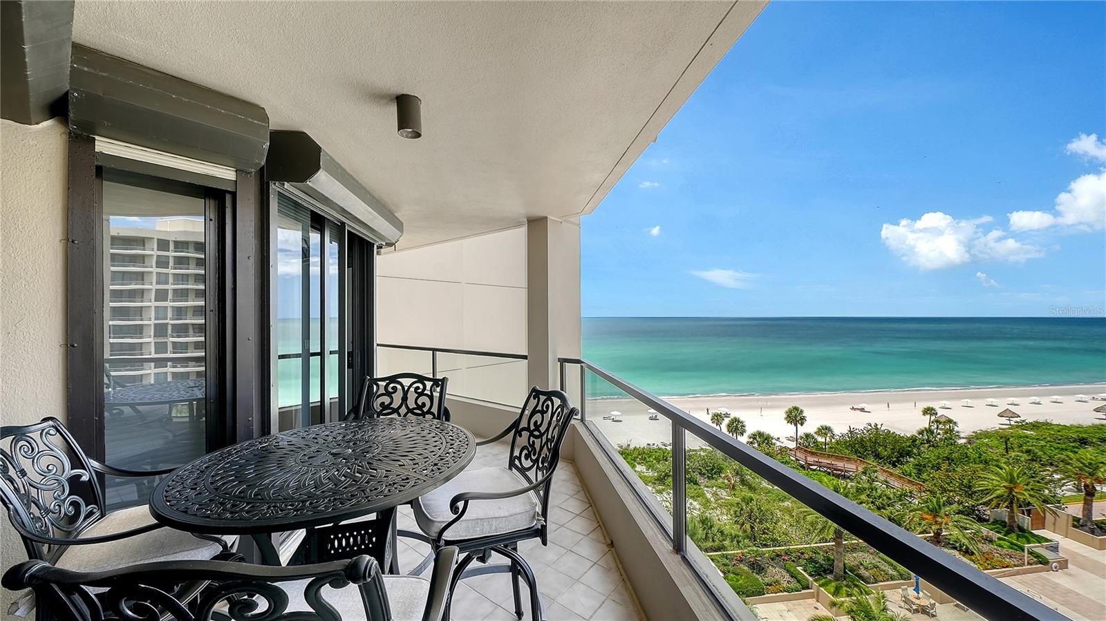 From sunrises over Sarasota Bay to breathtaking sunsets across the Gulf of Mexico, this sixth-floor residence at Promenade captures the panoramic water views that define Longboat Key living. Positioned along the sought-after southern end of the island, this beautifully maintained two-bedroom residence spans more than 1,800 square feet (the largest of the two-bedroom layouts in the community) and enjoys sweeping vistas of turquoise Gulf waters, Sarasota Bay,  and the resort-style grounds below.
An extended foyer entry welcomes you into the open layout designed to maximize both natural light and water views. Walls of glass (equipped with storm shutters) frame the Gulf beyond while seamlessly connecting the living and dining areas to the wraparound terrace. Contemporary finishes, elegant flooring, and a neutral palette create a refined yet comfortable atmosphere throughout.
The renovated kitchen is thoughtfully designed for both everyday living and entertaining, featuring stone countertops, shaker-style cabinetry, stainless steel appliances, generous storage, and an adjacent breakfast area surrounded by Gulf windows that showcase sparkling beach views. Whether preparing a casual meal or hosting guests, the kitchen remains connected to the main living spaces while offering spectacular scenery from nearly every angle.
Privately situated within the split-bedroom floor plan, the primary suite serves as a peaceful retreat with Gulf views, terrace access, dual walk-in closets, and a spacious en-suite bath featuring dual vanities, a soaking tub, separate shower, and private water closet. The guest suite offers its own walk-in closet and en-suite bath, providing comfort and privacy for visiting family and friends.
Meticulously maintained and move-in ready, the residence also includes a dedicated laundry room, under-building parking, and private storage.
The Promenade is one of Longboat Key's premier Gulf-front communities, offering residents a full-service lifestyle with a 24-hour manned guard gate, concierge services, on-site management, secure lobby, fitness facilities, social rooms, four Har-Tru tennis courts, Gulf-front sundeck, oversized heated swimming pool and spa, and a private boardwalk leading directly to the beach. Residents enjoy the convenience of resort-style amenities paired with attentive service and beautifully maintained grounds. 
Ideally located near the Longboat Key Club's golf, tennis, and marina facilities, The Promenade places you just minutes from waterfront dining, boutique shopping, and the renowned attractions of St. Armands Circle. Downtown Sarasota's vibrant cultural scene—including The Ringling, Sarasota Opera, Selby Gardens, art galleries, theaters, and acclaimed restaurants—is only a short drive away. This exceptional residence offers the perfect opportunity to enjoy Gulf-front living, panoramic water views, and the very best of Sarasota's coastal lifestyle.
