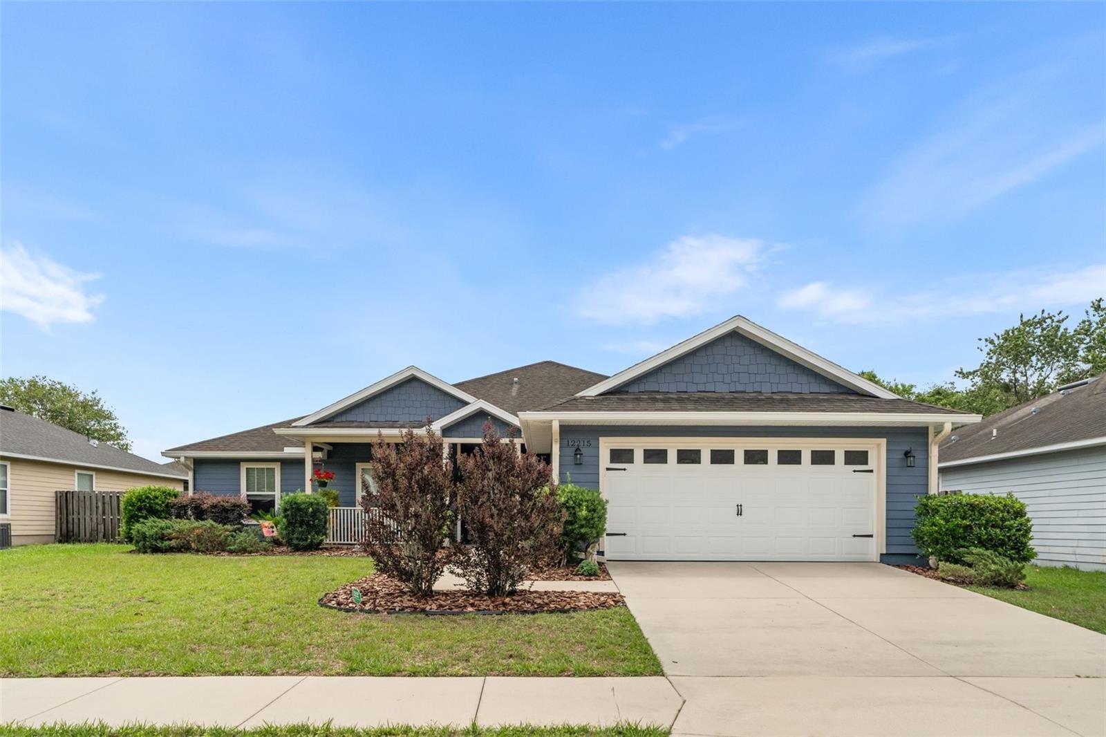 Beautifully maintained 2016 Fletcher-built 4-bedroom, 2-bath home in desirable Savannah Station featuring an open-concept floor plan with no wasted space and move-in ready condition. This immaculate home offers newer luxury vinyl plank flooring throughout the main living areas and one guest bedroom, high ceilings, recessed lighting, window shades, and fresh 2024 exterior paint. The spacious kitchen is designed for both style and function with gorgeous glazed soft-close cabinetry, granite countertops, stainless steel appliances, plus a new refrigerator and range. The private primary suite includes a huge walk-in closet and a luxurious en-suite bath with double vanities, garden tub, and glass-enclosed walk-in shower. A welcoming foyer opens into the large great room and dining area, while French doors with built-in blinds lead to a screened-in back porch with privacy shades for year-round comfort. Outside, enjoy beautifully manicured landscaping, privacy hedge rows, a fully fenced backyard, front and rear porches, and a spacious two-car garage and don’t miss the rain gutters. Conveniently located near I-75 with easy access to High Springs, Alachua, and Gainesville, this Savannah Station home offers the perfect blend of comfort, style, and location in one of North Central Florida’s growing communities. Low HOA and community offers a brand new pool, pavilion plus playground.