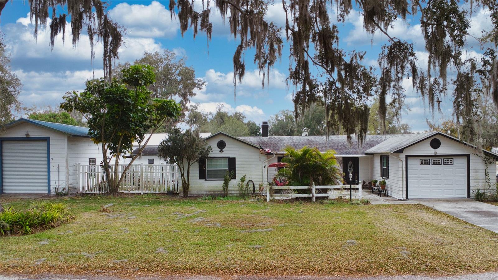 Motivated Seller! Welcome to 400 Wilson St NE in Fort Meade, FL—a charming and versatile property offering space, freedom, and no HOA restrictions. This 2-bedroom, 1 full bath, 1 half bath home features 1,329 sq ft of living space on a generous 0.29-acre lot. Inside, you’ll find a functional layout with an attached garage, while out back you can enjoy the covered patio space, perfect for relaxing or entertaining.
What truly sets this property apart is the detached 2-car garage plus an additional storage shed, offering ample room for vehicles, tools, hobbies, or extra storage. Property has working well that is used for irrigation. Looking for a place to store your RV or toys, you will have plenty of space in the large barn with water and electrical already hooked up !With USDA eligibility, this home may qualify for zero-down financing, making it an excellent opportunity for eligible buyers. Conveniently located and full of potential, this property is ideal for those looking for space, flexibility, and country-style living close to town. Buyers must verify all information.