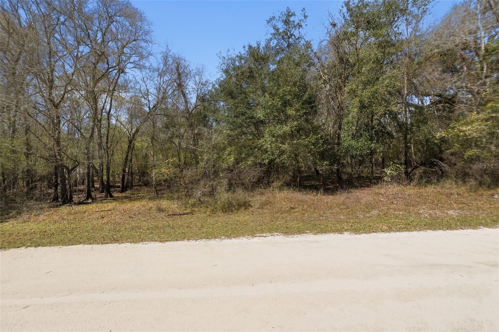 Tucked within a quiet cul-de-sac setting, this 0.70-acre vacant parcel presents an inviting opportunity to create a custom home while enjoying a comfortable balance of space, privacy, and natural surroundings. The property offers a flexible homesite with ample room to design a thoughtfully planned residence along with outdoor features such as a backyard retreat, garden areas, a pool, workshop, or a shaded patio where you can enjoy Florida’s warm climate and open skies. With its generous size, the lot allows for both privacy and creativity in planning the layout of your future home while still leaving space to enjoy outdoor living and the surrounding landscape. Electric and telephone service are already available on the lot, while additional utilities are located nearby, helping simplify the planning process and supporting a smoother path from concept to construction. The peaceful cul-de-sac location creates a quiet atmosphere with minimal traffic, making it easy to imagine relaxed mornings, unhurried afternoons, and evenings spent outdoors in a home designed to reflect your vision. The property’s setting also offers the convenience of being close to nearby roadways and neighboring communities, allowing you to enjoy a more private environment while still remaining connected to everyday necessities. Beyond the neighborhood, residents have convenient access to several well-known outdoor destinations including Withlacoochee State Forest, which offers miles of scenic trails for hiking, biking, and horseback riding, and the popular Webster Westside Flea Market, one of the largest open-air markets in the region and a local weekend destination. Additional nearby attractions include Weeki Wachee Springs State Park, where visitors enjoy kayaking, paddleboarding, and exploring the beauty of its clear spring waters, along with nearby towns that provide shopping, dining, and everyday conveniences, creating a setting that blends quiet residential living with outdoor recreation and accessibility.