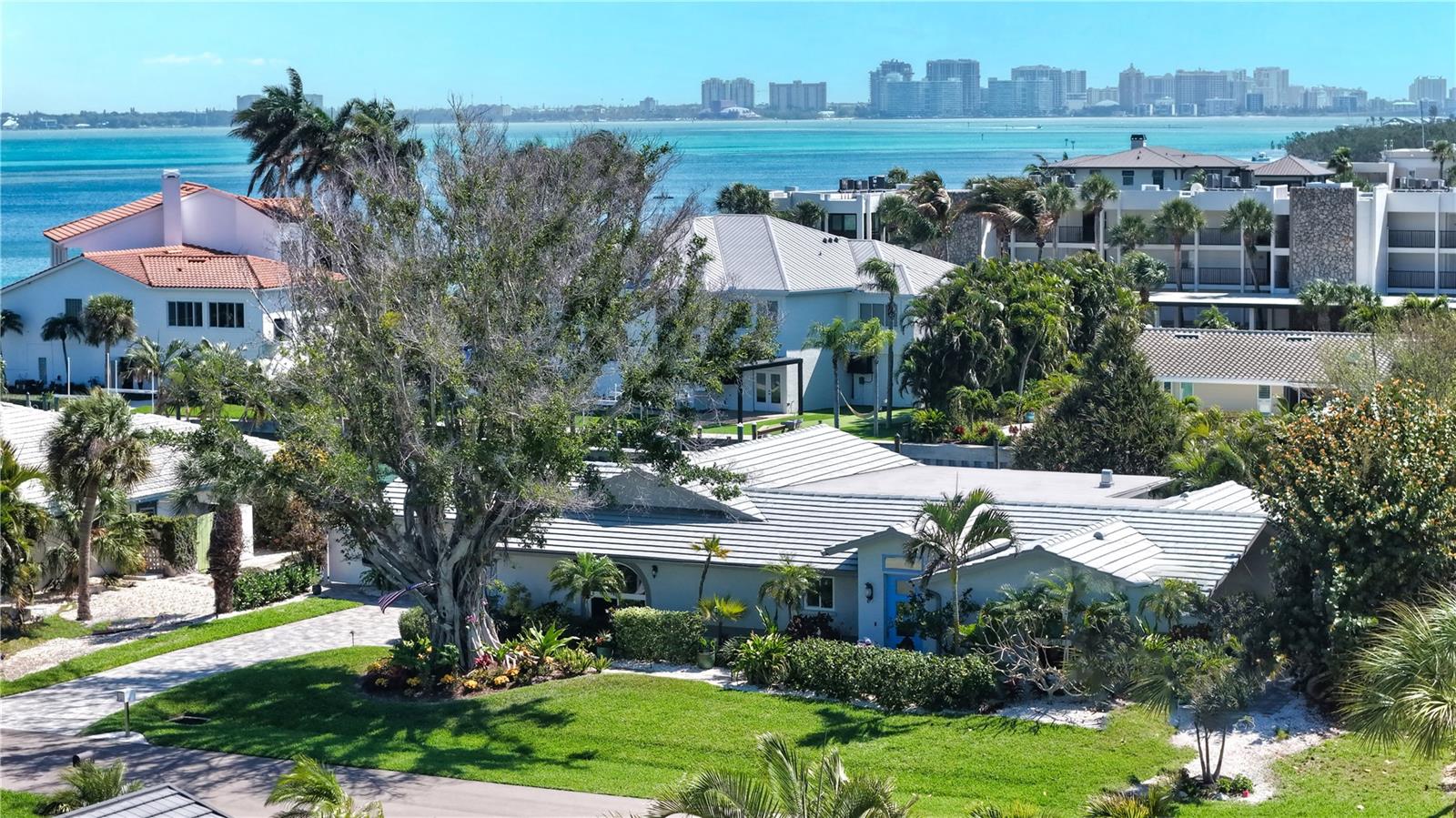Seller motivated and offering peace of mind with no hurricane damage, this extraordinary south Longboat Key canal-front home in Country Club Shores presents a rare opportunity to experience luxury coastal living at its finest. Perfectly positioned just two in from Sarasota Bay, this completely renovated approximately 3,000-square-foot residence seamlessly blends elegance and tranquility. Featuring 3 bedrooms, 3 bathrooms, an open-concept layout, a dedicated media room, and a private office, the home showcases exceptional craftsmanship throughout, including impact windows, 10-foot ceilings, custom millwork, and large plank porcelain flooring. At the heart of the home, the gourmet kitchen is a true showpiece, highlighted by a striking 9-foot Dolomite island, Thermador refrigerator and freezer columns, and a 48-inch six-burner gas range. Expansive 12-foot bifold impact doors and 8-foot bifold windows fully open to create a seamless indoor-outdoor flow, connecting the kitchen to the patio and capturing breathtaking bay views. The owner’s retreat offers a serene, Zen-inspired escape with calming tones and water vistas, complemented by a luxurious two-person hydrojet bath aroma steam shower with dual rain heads and hand showers. Designed for both relaxation and entertaining, the media room features surround sound and a wet bar with a refreshment center, while the separate office provides dual workspaces and a pull-out sofa for additional guests. Two generously sized guest suites offer luxurious bathrooms with floor-to-ceiling large-format porcelain tile and premium fixtures. Outdoors, a 110-foot seawall and versatile dock system provide the ultimate waterfront lifestyle, complete with an entertaining area, mooring station with shore power and water, and a floating dock ideal for kayaking or boating. Ideally located on the highly sought-after South end of Longboat Key, adjacent to the Resort at Longboat Key Club and just moments from St. Armands Circle, this exceptional property also includes deeded beach access and convenient proximity to Sarasota. Schedule your private tour today and discover this one-of-a-kind coastal retreat.