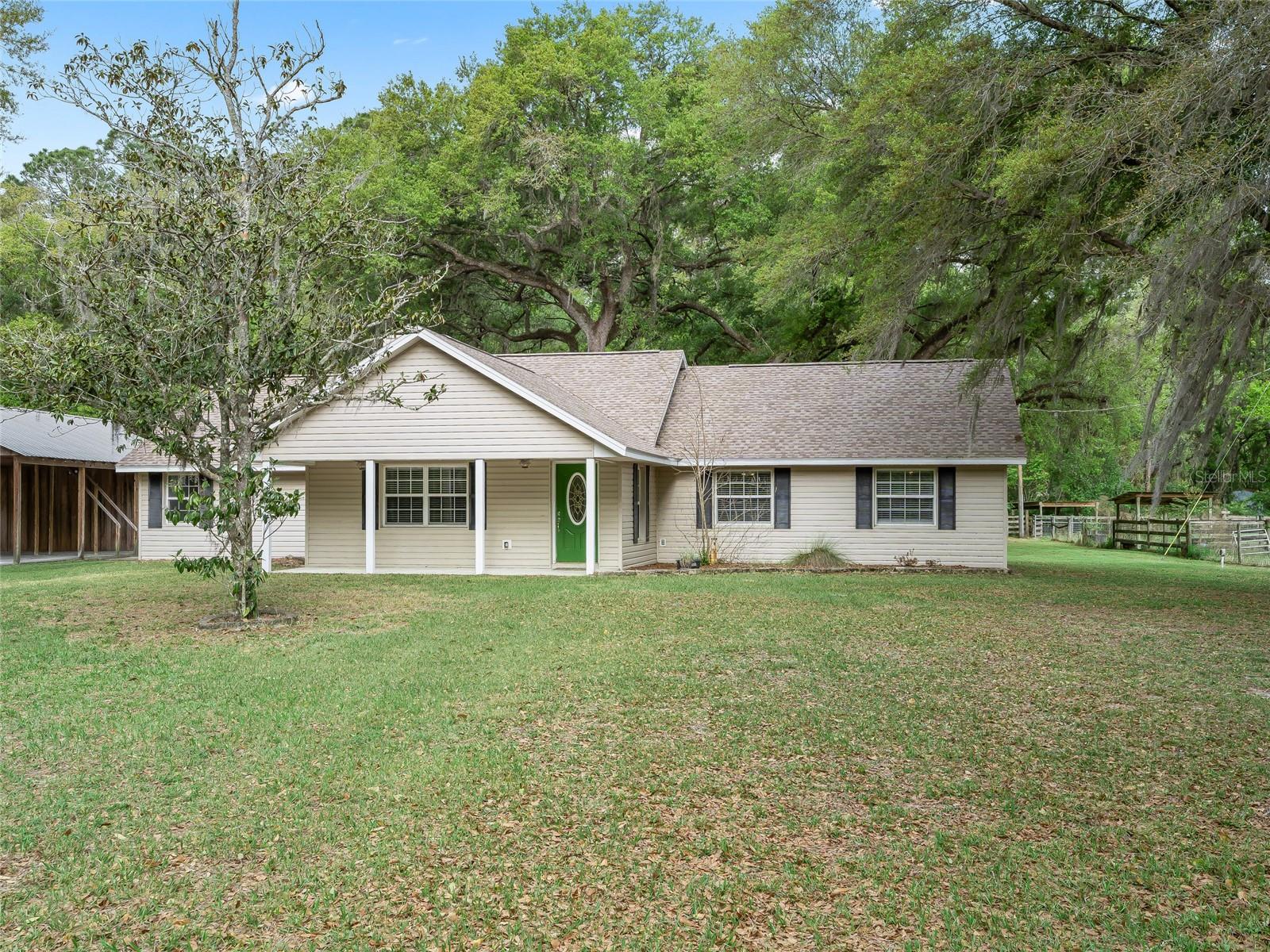 NO HOA!! LOCATION LOCATION!! Experience the charm of country living on this beautiful 6.81 acre property, ideally situated on a spacious corner lot shaded by stunning oak trees. This 4-bedroom, 3-bath totally remodel home is set back off the road, offering privacy, tranquility, and that true rural atmosphere buyers are looking for.
Inside, you’ll find a warm and inviting wood-burning fireplace perfect for those cooler evening and a comfortable, functional layout designed for everyday living. This home features two primary bedrooms, each with its own private bathroom, offering flexibility for multi-generational living or guest accommodations. The kitchen includes a brand-new refrigerator, with all other appliances approximately 5 years old or newer. Major updates include a new roof (2024) and two water heaters (2024 & 2022). The A/C system is approximately 10 years old.
Step outside to the large screened-in back porch an ideal place to relax and take in the peaceful surroundings.
This property is set up and ready for your animals! Bring the horses, cows, and all your toys there’s a separate pasture area with two stalls already in place. The impressive 30x80 pole barn with loft and attached workshop (with electric) offers endless possibilities and could easily function as a feed room, hay storage, or tack room. You’ll also appreciate the covered RV/boat parking, making this property as functional as it is beautiful.
The west and south sides of the property are lined with trees, creating a private, secluded setting where you can enjoy nature and frequent wildlife including wild turkeys roaming the land.
Whether you’re looking for a mini farm, a place to spread out, or simply enjoy the quiet country lifestyle this property offers endless possibilities. Very convenient to local grocery stores and restaurants. Easy commute to I-75 which goes to Tampa, Ocala and the turnpike. Call today for appointment.
