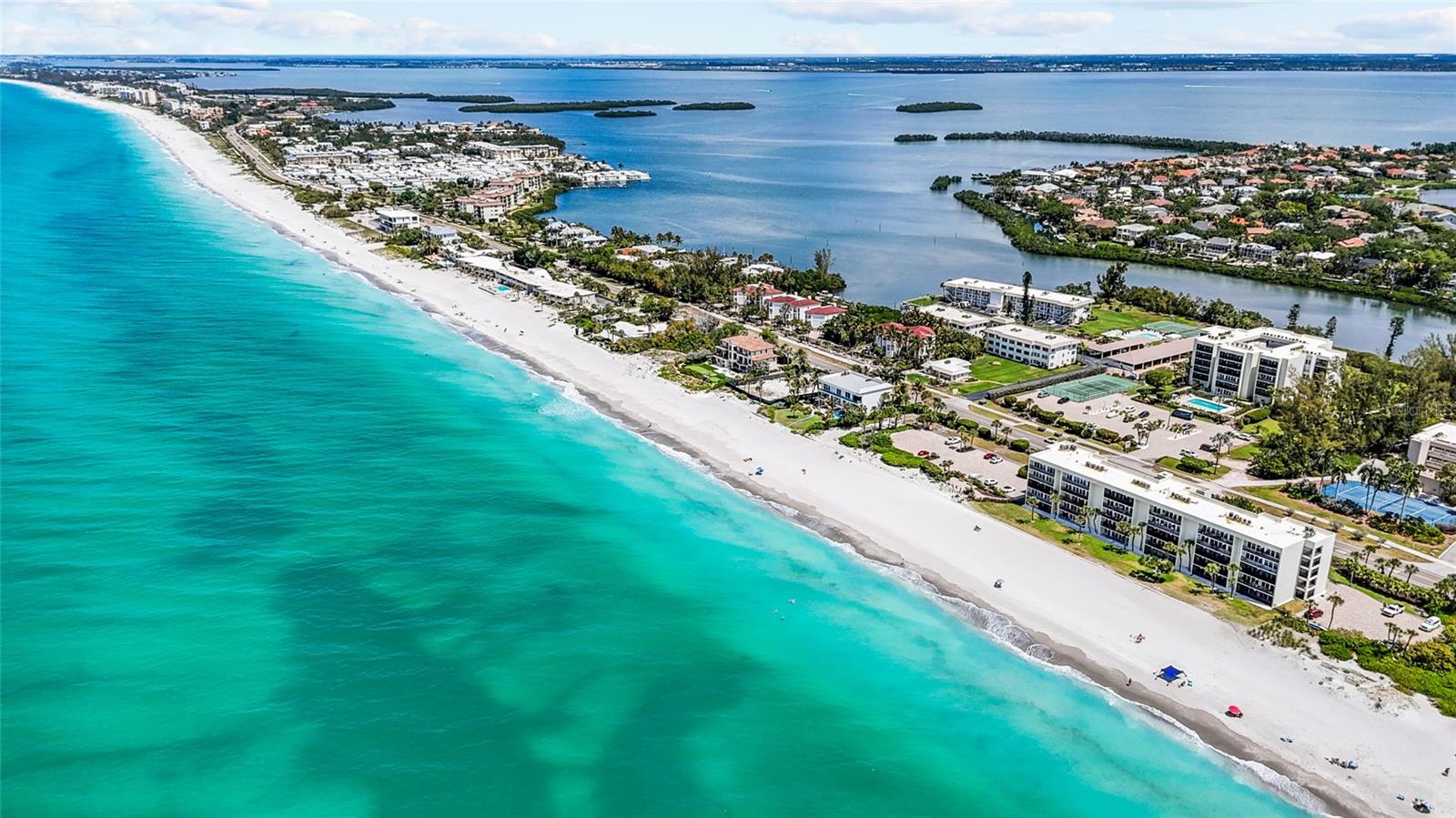 Island Elegance on the Bay: A Turnkey Waterfront Sanctuary! Escape to the serene shores of Longboat Key and experience the pinnacle of coastal luxury at 3330 Gulf of Mexico Drive. This meticulously reimagined, two-bedroom, two-bathroom residence offers a rare "walk-out" lifestyle, where lush green lawns meet the shimmering waters of the Sarasota Bay. The Interior: Modern Luxury Meets Tropical Soul. No detail was spared in this fully renovated, turnkey-furnished masterpiece. Step inside to find an open-concept sanctuary defined by high-end finishes and a sophisticated "island chic" aesthetic. Gourmet Kitchen: Features crisp white cabinetry, designer backsplash, and premium stainless steel appliances, perfect for the culinary enthusiast. Designer Living: Relax in a sun-drenched living area adorned with organic textures, custom wood-slat feature walls, and curated furnishings that reflect the colors of the coast. Master Suite: A true retreat, the primary bedroom opens directly to the outdoors, allowing you to wake up to the gentle sounds of the bay and the rustle of palm trees. Spa-Inspired Baths: Indulge in sleek, modern bathrooms featuring frameless glass showers, backlit mirrors, and contemporary vanities. The "Florida Room" Experience: The heart of this home is the climate-controlled Florida Room. Encased in floor-to-ceiling glass, this versatile space offers an effortless transition to the outdoors. Whether you're sipping your morning coffee or hosting a sunset dinner, you'll enjoy front-row views of local wildlife, passing boats, and the sparkling bay. Unrivaled Amenities & Location: Situated within the coveted Longboat Arms community, you'll enjoy a resort-style lifestyle with access to: Waterfront Perks: Private boat slips, a boat ramp, and kayak storage for the ultimate bayfront adventure. Leisure & Sport: A heated community pool and tennis courts just steps from your door. Deeded Beach Access: Simply cross the street to sink your toes into the world-famous white sands of Longboat Key's private beaches. Prime Location: Located on the south end of the Key, you are mere minutes from the upscale dining, boutique shopping, and cultural arts of St. Armands Circle and Downtown Sarasota. Your Turnkey Paradise Awaits: Offered fully furnished with a curated selection of "Artful Living" decor, this condo is ready for immediate enjoyment. Whether you're looking for a seasonal getaway or a permanent slice of paradise, this is the coastal retreat you've been waiting for. Experience the beauty for yourself. Welcome home to Longboat Key.