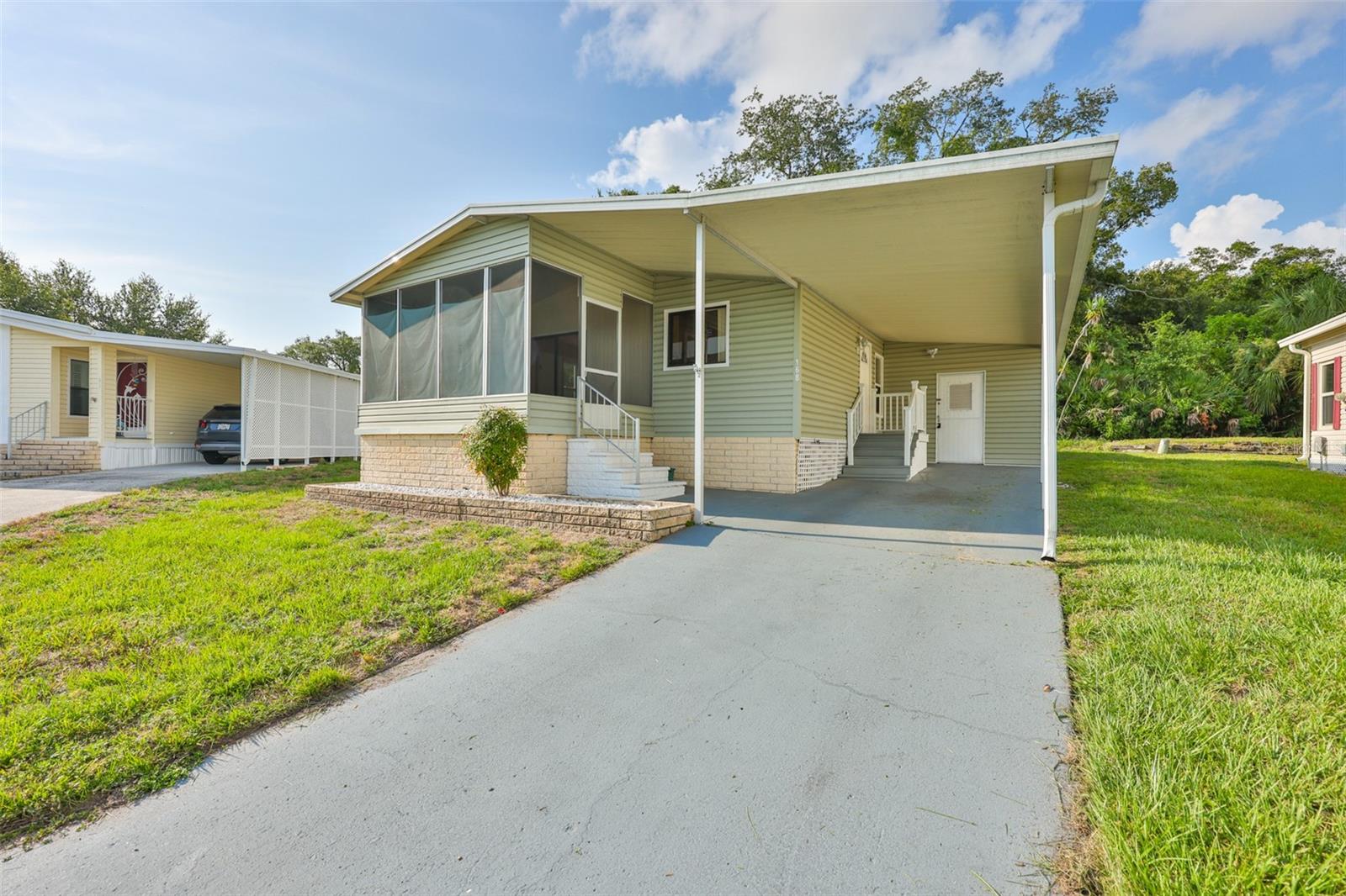 Virtually Staged. Welcome to Florida living in this land owned 55+ active adult community located in a NO Flood Zone! This beautifully maintained corner lot home backs up to a peaceful conservation area, offering extra privacy and relaxing natural views.
Freshly painted inside, this bright and inviting home features 2 bedrooms, 2 bathrooms, laminate flooring, a spacious living room with vaulted ceilings, and a dining area with charming built-in cabinetry. The kitchen is designed for functionality with a cast iron triple sink, instant hot water tank, and peninsula countertop for extra prep and seating space.
Enjoy the Florida lifestyle from the covered screened front porch, perfect for morning coffee or evening relaxation. The enclosed shed includes a laundry room, built-in shelving, and plenty of additional storage space. Additional upgrades include updated windows, electrical panel replaced in 2015, long driveway, and covered carport parking.
Low monthly HOA includes water, sewer, trash, lawn care, and access to resort style amenities: Heated pool and spa; Clubhouse with social activities; Fitness center; Shuffleboard and Bocce Ball courts; RV and boat parking area.
Located only 13 miles from world famous, this home is ideal for full time Florida living or a seasonal retreat near beaches, shopping, dining, and entertainment.
Move in ready, low maintenance, and packed with value. Enjoy easy Florida living in a vibrant and friendly community!