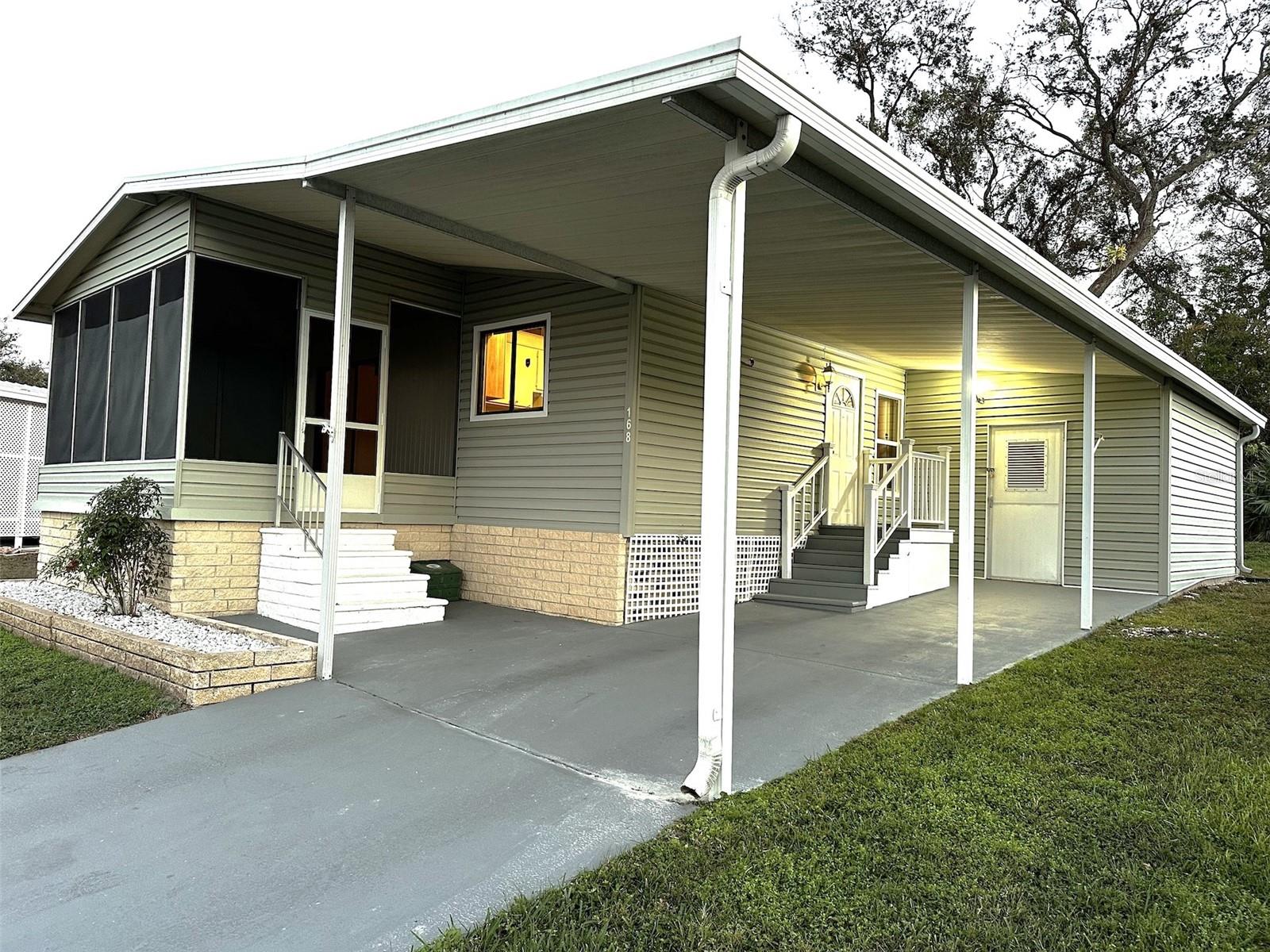 Welcome to Florida living in this land owned 55+ active adult community located in a NO Flood Zone! This beautifully maintained corner lot home backs up to a peaceful conservation area, offering extra privacy and relaxing natural views.
Freshly painted inside, this bright and inviting home features 2 bedrooms, 2 bathrooms, laminate flooring, a spacious living room with vaulted ceilings, and a dining area with charming built-in cabinetry. The kitchen is designed for functionality with a cast iron triple sink, instant hot water tank, and peninsula countertop for extra prep and seating space.
Enjoy the Florida lifestyle from the covered screened front porch, perfect for morning coffee or evening relaxation. The enclosed shed includes a laundry room, built-in shelving, and plenty of additional storage space. Additional upgrades include updated windows, electrical panel replaced in 2015, long driveway, and covered carport parking.
Low monthly HOA includes water, sewer, trash, lawn care, and access to resort style amenities: Heated pool and spa; Clubhouse with social activities; Fitness center; Shuffleboard and Bocce Ball courts; RV and boat parking area.
Located only 13 miles from world famous, this home is ideal for full time Florida living or a seasonal retreat near beaches, shopping, dining, and entertainment.
Move in ready, low maintenance, and packed with value. Enjoy easy Florida living in a vibrant and friendly community!