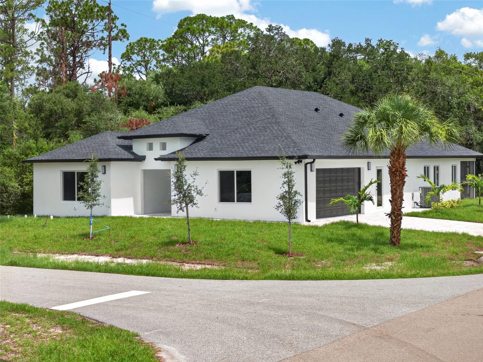 WHERE MODERN LUXURY MEETS EVERYDAY LIVING. Welcome to this exceptional 2026-BUILT 4 BEDROOM, 3 BATHROOM, 2 CAR GARAGE CUSTOM HOME, where sophisticated design, premium finishes, and meticulous craftsmanship come together to create a truly unforgettable residence. Perfectly positioned on a CORNER LOT in a quiet, low-density area of Port Charlotte, this stunning home offers a sense of privacy and tranquility while remaining just minutes from shopping, dining, golf, boating, and Southwest Florida's beautiful Gulf Coast beaches.

From the moment you step through the front door, you'll be captivated by the home's soaring HIGH CEILINGS, expansive open-concept design, and an abundance of natural light that creates a bright, airy atmosphere. Every space has been thoughtfully designed to maximize both functionality and elegance, delivering a home that feels grand while remaining warm and inviting.

The chef-inspired kitchen serves as the centerpiece of the home, featuring STAINLESS STEEL APPLIANCES, a DOUBLE WALL OVEN, an oversized CENTER ISLAND, and EXTRA-TALL CUSTOM CABINETRY that extends toward the ceiling, offering abundant storage while enhancing the home's clean, contemporary aesthetic. Whether preparing everyday meals or entertaining guests, this space is designed to impress.

The luxurious primary suite is a true private retreat. Wake each morning to peaceful views with SLIDING GLASS DOORS LEADING DIRECTLY TO THE EXPANSIVE LANAI, creating a seamless indoor-outdoor connection. Dual WALK-IN CLOSETS, each appointed with CUSTOM BUILT-IN ORGANIZATION SYSTEMS, provide exceptional storage, while the spa-inspired ensuite bath showcases a DUAL VANITY, elegant finishes, a BACKLIT LED MIRROR, and a sophisticated design that evokes the feel of a luxury resort.

The guest accommodations are equally impressive. Each of the generously sized bedrooms features its own CUSTOM BUILT-IN CLOSET ORGANIZATION SYSTEM, elevating both style and functionality while providing exceptional storage rarely found in new construction homes.

Step outside to the SPACIOUS COVERED LANAI, perfectly designed for relaxing evenings, outdoor dining, and future customization. With ample room for entertaining or creating your own backyard oasis, the outdoor living space offers endless possibilities.

Built in 2026, every detail of this home reflects today's most desirable finishes and construction standards, allowing you to enjoy the confidence and efficiency of brand-new construction without compromise.

If you've been searching for a home that offers exceptional craftsmanship, timeless modern design, and luxurious finishes in a peaceful Port Charlotte setting, your search ends here.

THIS IS MORE THAN A HOME—IT'S A STATEMENT OF MODERN ELEGANCE, THOUGHTFULLY DESIGNED FOR THE WAY YOU WANT TO LIVE.
