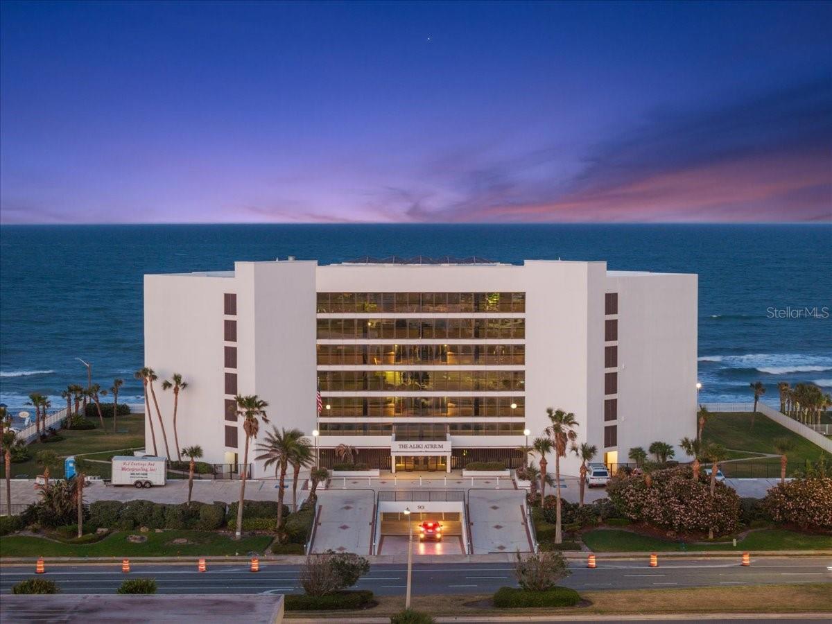 Welcome to one of Ormond Beach's most extraordinary coastal residences—a rare opportunity to own the only 4-bedroom, 3-story penthouse available in the prestigious Aliki Atrium. Offering the space and privacy of a luxury home with the effortless lifestyle of oceanfront condominium living, this remarkable residence invites you to experience the beach from an entirely new perspective.

As you step through the beautifully landscaped atrium, you're welcomed by lush tropical gardens, the gentle sound of flowing water, and a sense of tranquility that immediately sets the tone. Ride the elevator to the penthouse, where the front door opens to breathtaking views of the Atlantic Ocean, drawing your eyes beyond the expansive living spaces and out to the endless horizon.

The main level was thoughtfully designed for gathering. Whether you're preparing a casual breakfast before a sunrise walk on the beach or hosting an evening with family and friends, the spacious kitchen is both beautiful and functional, featuring stone countertops, a generous closet pantry, and a dedicated laundry room tucked just beyond. The kitchen flows seamlessly into the dining and living areas, where walls of glass invite natural light inside and lead to a private balcony overlooking the coastline. Here, every meal, conversation, and quiet moment is accompanied by the soothing rhythm of the waves.

Ascend to the upper levels and discover four private bedroom suites, each designed as its own personal retreat. Every bedroom offers an en-suite bathroom, multiple walk-in closets, and a private balcony where you can begin your mornings with coffee as the sun rises over the Atlantic or unwind each evening with the salty ocean breeze and the sound of crashing surf below. The thoughtful three-story layout creates exceptional privacy, making this home equally suited for everyday living, hosting extended family, or welcoming overnight guests.

Outside your front door, resort-style amenities continue the experience. Spend the afternoon lounging beside the heated oceanfront pool, stroll directly onto the sandy shoreline, or simply relax within the stunning garden courtyard that makes Aliki Atrium one of the area's most distinctive residences.

Completing the package are two covered parking spaces in the secured underground garage, each with built-in storage, along with ample guest parking offering convenient access to the pool and beach. Perfectly positioned in the heart of Ormond Beach, you'll enjoy being just steps from Riptides Bar & Grill and Planet Fitness, while Publix, Belair Plaza, local boutiques, restaurants, and everyday conveniences are all just minutes away.

This is more than a penthouse—it's a home where every floor tells its own story, every balcony frames a new view of the Atlantic, and every day feels like a vacation. Opportunities to own a residence this unique are exceptionally rare. Welcome home.