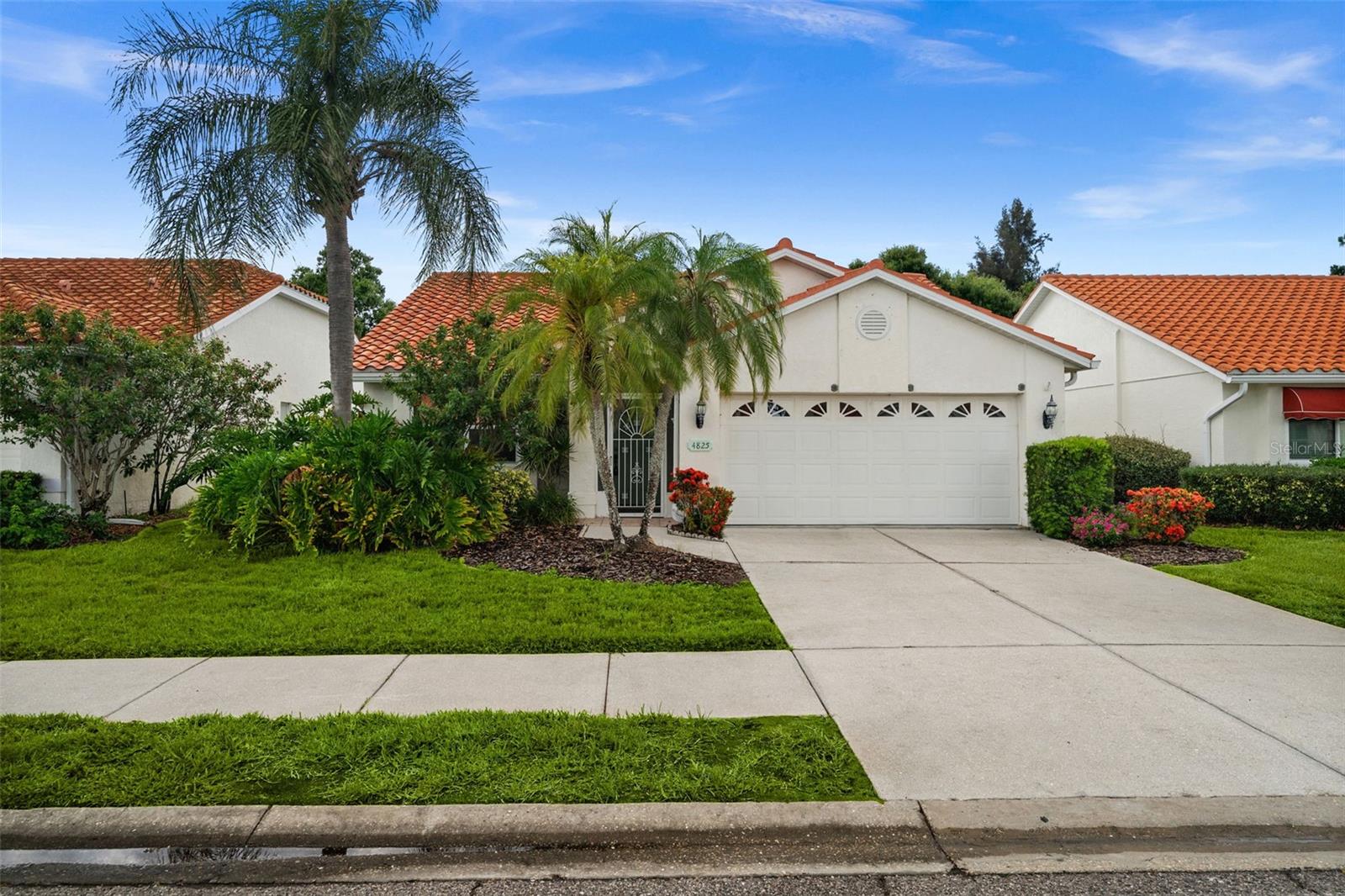 Welcome to 4825 Tamarack Trail, a spacious 3-bedroom, 2-bath, 2-car garage villa tucked away in a quiet section of the highly desirable Southwood community. This maintenance-free home offers privacy and tranquility, backing up to a protected nature preserve with no rear neighbors—just peaceful views and nature. Built with quality and designed for comfortable living, this home features vaulted ceilings, an open, flowing floor plan filled with natural light and recently updated flooring. Pocket sliding glass doors open to a large glass-enclosed lanai, creating the perfect space to relax and enjoy year-round Florida living. The new washer and dryer are included in the purchase price, making this home truly move-in ready. The generous primary suite includes dual sinks, his-and-her walk-in closets and a spacious walk-in shower with a built-in bench. Hurricane shutters provide added peace of mind and the durable tile roof was replaced in 2014. Conveniently located just minutes from shopping, restaurants and everyday conveniences, this home also offers easy access to the vibrant Wellen Park district, featuring dining, entertainment, events and the Atlanta Braves’ spring training facility. Plus, you’re only a short drive from the beautiful Gulf Coast beaches, where you can enjoy boating, fishing, spectacular sunsets and the Florida lifestyle you’ve been dreaming of. If you’re looking for a home with solid construction, a fantastic layout, privacy and an unbeatable location, 4825 Tamarack Trail is ready to welcome you home.