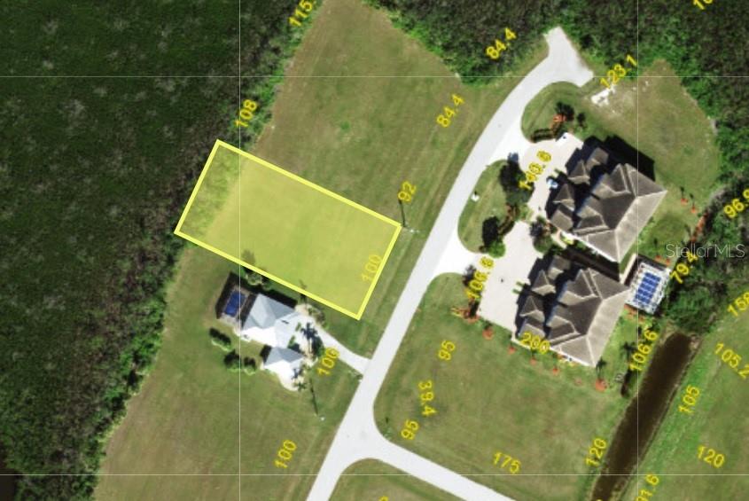 In a quiet corner of Burnt Store Lakes you can build your dream home with this  large 1/2 acre lot that includes city water and sewer! This level and cleared buildable lot is among just a few that are large enough for a spacious home with 3 car garage and more privacy all around. Facing east in front and west in the back, you'll enjoy glorious sunrise and sunset views year round! A protected mangrove buffer in back lets you enjoy your pool and outdoor activities with no neighbors in back and this street has very little traffic. Burnt Store Lakes is a well-established community with deed-restrictions to protect property values and greenbelts between lots, plenty of walking paths for a daily stroll, and a community park with picnic areas and a resident’s kayak/canoe launch providing water access to Charlotte Harbor. Just a golf cart ride away is neighboring Burnt Store Marina where you can store your boat or join Freedom Boat Club, play golf on a 27 hole executive course, dine in two onsite restaurants and a Ship’s Store and enjoy unparalleled waterfront amenities with immediate access to Charlotte Harbor. Charming downtown Punta Gorda is a short drive for shopping, restaurants, and year-round events. And burgeoning Cape Coral is just down the road with a growing variety of stores and services. Whether you’re an investor or planning to build your own custom home, this property offers space, privacy, and a great location. Start your Florida future right here!