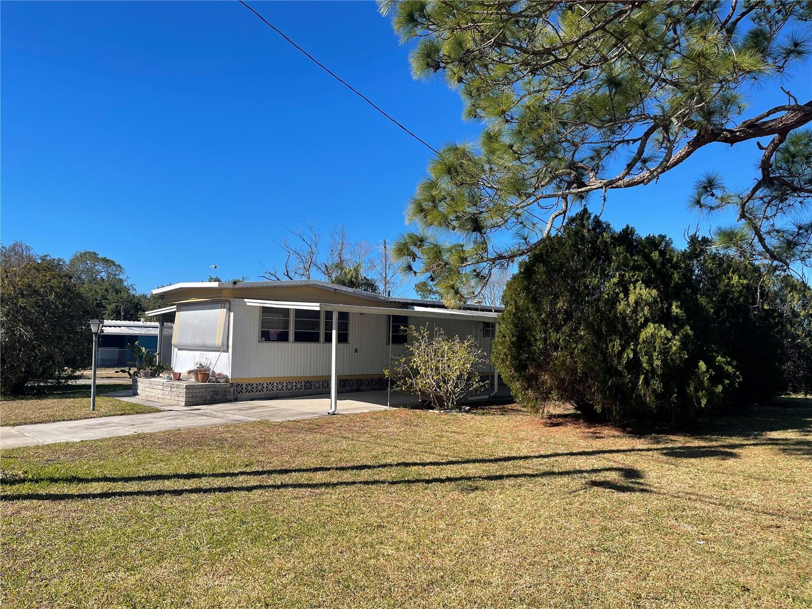 Best deal in Port Richey. No HOA or park fees. The owner owns the land. This home sits on a tranquil double lot with beautiful trees between it and the neighbor for privacy and which help make for a nice and peaceful setting. The double lot includes lots 6523 and 6527 Sandra Dr. New insulation was installed beneath the floors and inside the lower part of the side walls all the way around the house. It has a huge storage room behind the house a second storage/laundry room as well. The lot sits at the end of the street, so barely any traffic passes by the house. It's just a few blocks from US hwy 19, so it's very convenient to shopping, great restaurants, theaters and to some of the best beaches in the US.