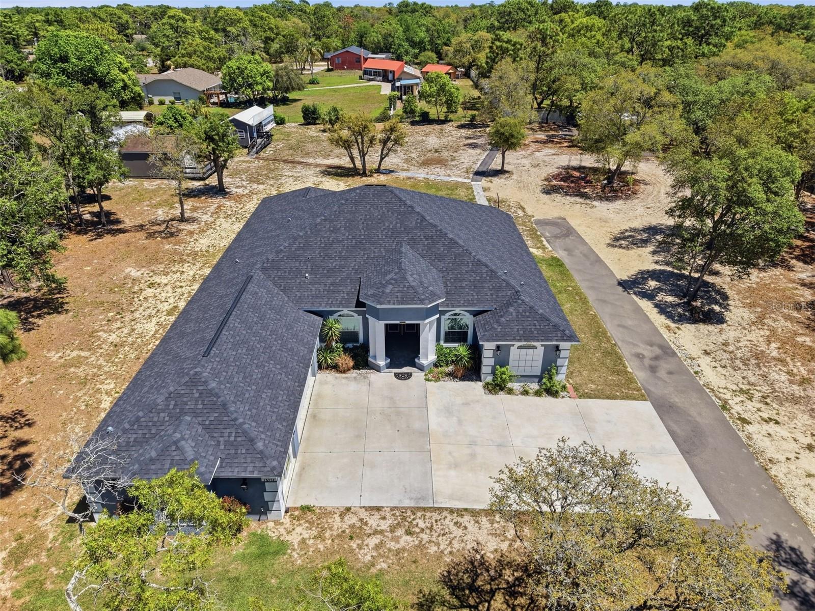 Stunning 2023 custom home by Dream Custom Homes situated on 1.54 acres, offering 4 bedrooms plus a dedicated office, 4 bathrooms, and modern upgrades throughout. This move-in ready home combines the privacy of agricultural zoning with the convenience of being close to shopping, dining, and just 45 minutes to Tampa.

Step inside to a spacious open-concept floor plan designed for both everyday living and entertaining. The kitchen features beautiful granite countertops, ample cabinetry, and flows seamlessly into the main living areas. A dedicated office provides the perfect work-from-home space or flex room. Home is fully wired for WIFI. 

Enjoy Florida living at its best with an extended paver lanai, ideal for relaxing or hosting guests. The property also includes a large 20x16 ft shed, perfect for storage, a workshop, or hobby space. Fully fenced.

This home was built with both quality and future planning in mind, featuring underground electrical service (no overhead wires), a 300-amp electrical panel prewired for a future pool, and newer construction for energy efficiency and peace of mind.

A rare find, the entire home is fully wheelchair accessible, offering comfort and functionality for a wide range of buyers.

If you're searching for a newer construction home on acreage, a custom home with land, or a 4 bedroom home with office near Tampa--this property checks all the boxes. Schedule your private showing today.