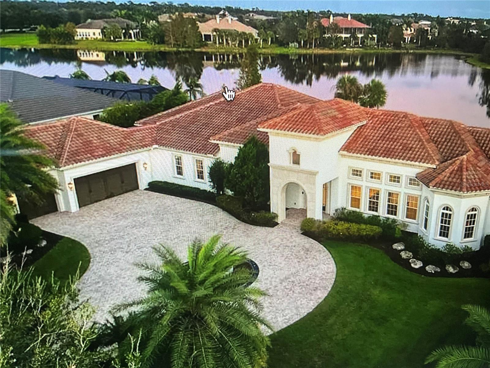 Experience exceptional Florida living in this beautifully appointed Arthur Rutenberg home located in the highly sought-after Concession community. Set on a private homesite with breathtaking southeast-facing lake views, this residence offers a perfect balance of elegant design, luxurious finishes, and effortless indoor-outdoor living.

From the moment you enter through the elegant iron and glass double doors, you are welcomed by an open and inviting floor plan filled with natural light. Beautiful coffered ceilings, travertine flooring, and expansive pocket sliding glass doors create a seamless connection between the interior living spaces and the spectacular outdoor retreat.

The spacious great room provides the ideal setting for both everyday living and entertaining, with stunning water views as the backdrop. The chef’s kitchen is designed to impress, featuring custom cabinetry with upgraded lighting, a large floating island, quartz countertops, walk-in pantry, Wolf gas cooktop, beverage refrigerator, and high-end stainless-steel appliances. The adjacent dining area and stylish bar create the perfect atmosphere for hosting family and friends.

A dedicated private office offers a quiet space for work or study, while the oversized bonus room provides endless possibilities as a home theater, golf simulator, game room, or fitness space—all while enjoying beautiful lake views. Three spacious guest suites are thoughtfully positioned for privacy, making this home ideal for hosting visitors.

The owner’s suite is a peaceful retreat featuring a sitting area, generous walk-in closets, and a luxurious spa-like bathroom complete with dual vanities, soaking tub, and a walk-in shower.

Step outside to your private outdoor oasis where the expansive lanai showcases travertine pavers, a fully equipped outdoor kitchen, and a stunning saltwater pool and spa. The 12’ x 61’ pool includes a sun shelf and fountains, creating a resort-style experience while overlooking the tranquil lake. Whether enjoying a morning coffee, entertaining guests, or relaxing at sunset, this outdoor space delivers the ultimate Florida lifestyle.

This exceptional home has been enhanced with numerous upgrades for comfort, convenience, and peace of mind, including newer air-conditioning systems, a whole-house generator, Ring security features, Culligan reverse osmosis water system, and a designer audio system. Additional improvements include sealed travertine surfaces, a newer pool cage, electric hurricane shades, outdoor TV wiring, accent lighting, refreshed landscaping, updated irrigation, front landscape lighting, upgraded electrical features, garage storage racks, added utility connections, and new flooring in a guest bedroom. New carpet installed in 2026.

Located in The Concession, one of the region’s most luxury private communities and host to major PGA Tour championship events, residents enjoy a peaceful, luxurious setting surrounded by natural beauty. This remarkable home offers an unmatched combination of elegance, privacy, and resort-style living.