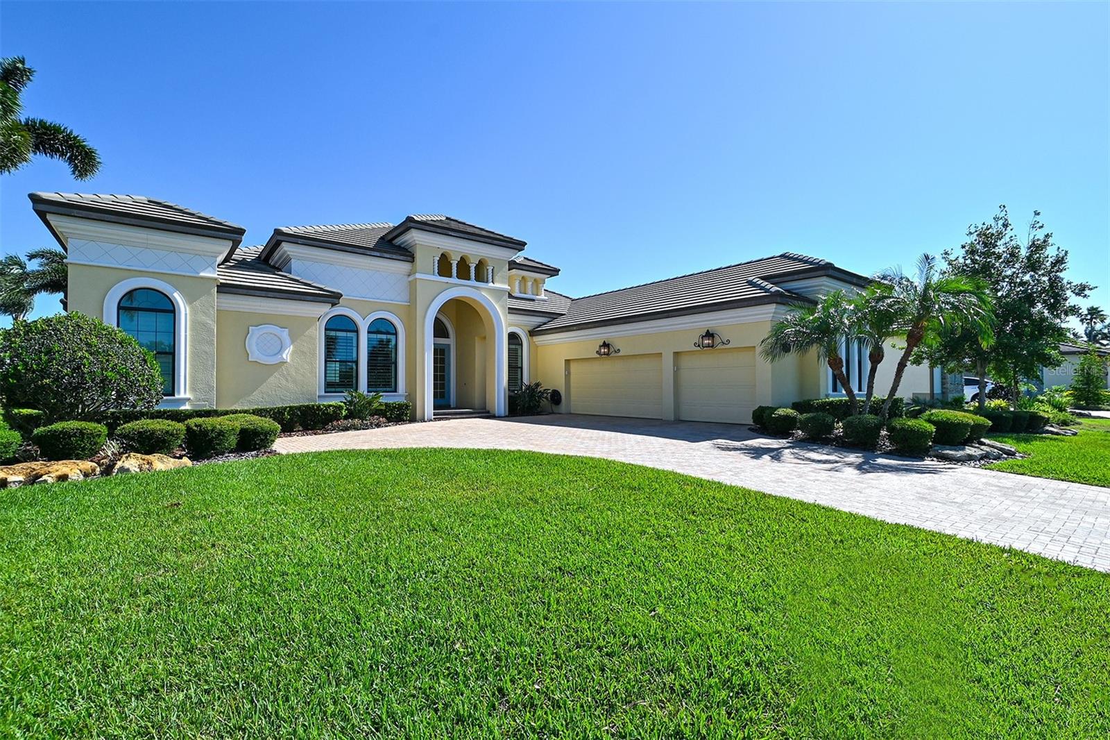 Light and bright pastels reflect the open water views from this immaculate classic coastal Rutenberg designed home. A gated community of newer homes, Hawk Island, offers everything you hope to find on a private island without the exposure and inconvenience. Mile wide water views of the Manatee River and protected deep water dockage on the canal define a gracious Florida lifestyle. Luxury features include high ceilings (12 ft) an open floor plan with four bedrooms, three baths, formal dining room and den office. High-impact rated sliding doors reveal the pebble stone saltwater pool, and travertine deck. The caged pool area features a spa, and gas fire pit. Noseeum mesh screening encourages full use of the outdoor shower and summer kitchen. Inside a flowing floor plan is accented with fine finishes that include porcelain tile floors throughout the main living areas, a cook’s kitchen with quartz counters, gas cooktop and oven, walk-in pantry, and wet bar. A separate master wing en suite arrangement with engineered wood floors in the bedroom, and marble bathroom with natural light throughout will satisfy the most discerning taste. The large garage has abundant cabinet storage, butcher block workspace, and new whole-house hot water on demand.

Hawk Island is located conveniently near shopping, and also provides quick access to I75 (3.5 miles). Work or play from Sarasota to St. Pete; it’s all within easy reach. Enjoy living on the pristine Manatee River with direct access to the Gulf of Mexico. Consider the mainland alternative to the seasonal crowding, traffic, red tide, and exposure on the barrier islands.
