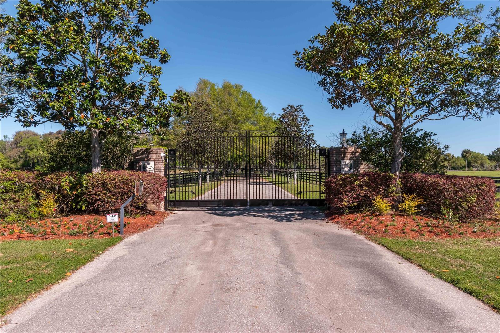 Welcome to a breathtaking equestrian sanctuary – a turn-key horse farm set on 150 rolling acres of pure paradise, just 25 minutes from the World Equestrian Center, and moments from both Ocala and Gainesville. Perfectly positioned only 5 minutes from the historic Ocala Jockey Club, this estate sits at the epicenter of Florida’s equestrian renaissance. This property offers not just a premier location—but a front-row seat to the future of elite equestrian living. Whether you're a competitive rider, investor, or passionate horse enthusiast, the potential for long-term value, enhanced amenities, and an unmatched lifestyle makes this a truly rare opportunity.
As you pass through the stately electric gate, a beautifully paved, tree-lined driveway leads you into the heart of this magnificent estate. Here, every detail is crafted for both form and function. The farm features 7 expansive paddocks, each outfitted with automatic waterers, ensuring your horses' comfort year-round. Across three dedicated paddocks, you'll find 26 sorting pens—ideal for cattle operations or multi-discipline training setups—while an impressive 80' x 160' arena, wrapped in pristine PVC fencing, offers the perfect space for practice, competition, or leisure riding.
At the center of the equine amenities stands a thoughtfully designed center-aisle, 7-stall barn, complete with an air-conditioned tack room, wash racks, and secure, fenced pastures—all blending convenience, luxury, and efficiency in one turn-key package.
Perched upon the rolling hills of horse country, the one-of-a-kind modern Victorian-inspired custom estate spans 4809 sqft. This meticulously designed home features a 50-year luxury laminate shingles roofing, ensuring both durability and timeless elegance. The interior is adorned with attention to detail and upgrades, offering four en-suite bedrooms, two additional half-baths, a built-in office, a bonus room, and a two-car garage converted into a gym with seamless epoxy flooring and a newly installed AC.
A transom front door welcomes you into the two-story foyer and grand staircase, leading to a private retreat in the form of the Master Suite. This sanctuary boasts spectacular views, a fireplace, a sitting area, and double French doors opening to a serene lanai overlooking the lush green backyard. The Master Suite also includes a spacious walk-in closet with its own washer/dryer and a spa-like bathroom.

Recent renovations add to the allure of this estate, including a fountain/aeration system in the front pond, new fencing, and a large raised garden. Approximately 80 acres of the property are adorned with pine trees, poised for harvest in the future years.

This property is not only a haven for horse enthusiasts but caters to the needs of cattle ranchers and individuals of various equestrian disciplines. The farm combines a convenient location, a private setting, exquisite design, and southern charm, making it stand out from other properties in the area. This is a once-in-a-lifetime opportunity to own a truly amazing turn-key farm – an idyllic blend of luxury and functionality, perfectly tailored to satisfy all your equestrian needs. Don't miss the chance to make this extraordinary estate your own.