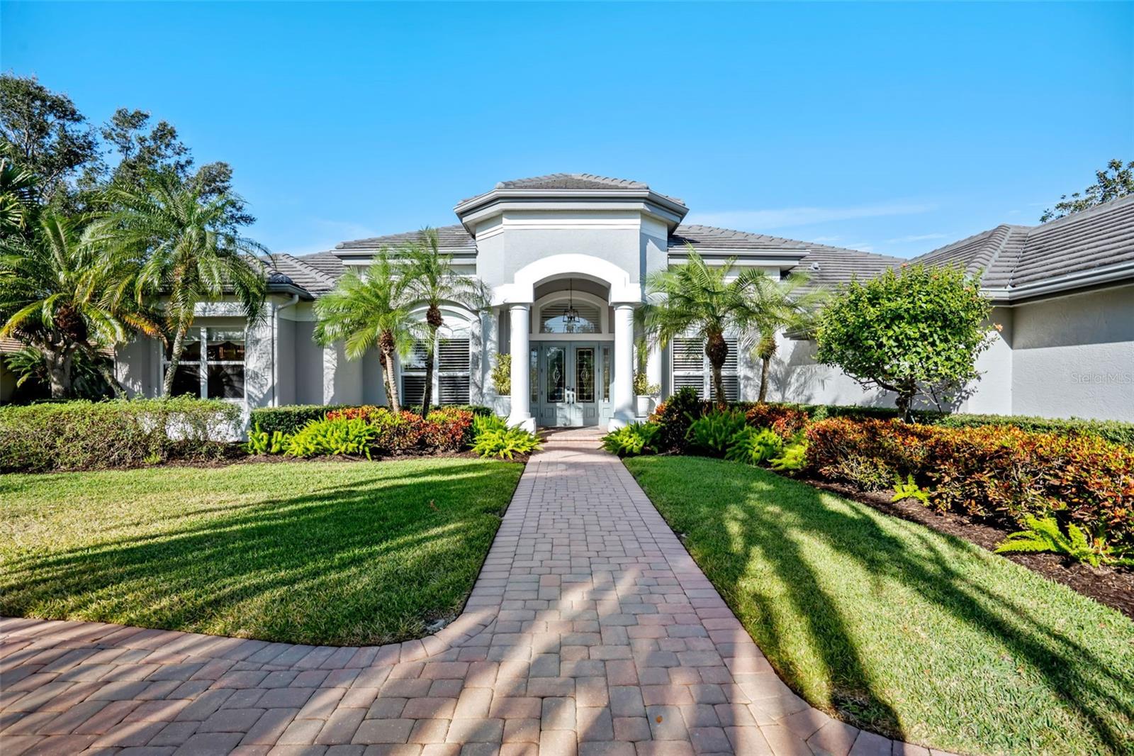 Schedule a private showing to tour this 4-bedroom, 4-bath pool home with an additional designated office/den. Strategically positioned on the Jones Course 8th fairway in Laurel Oak Estates, the residence offers 3,833 square feet of interior living space. Upon entering through the double leaded, beveled glass-door entry, you are immediately drawn to the home’s spacious layout, thoughtful design, and tasteful appointments. Highlights include high ceilings, abundant natural light, and a seamless flow between living spaces that enhance both comfort and livability. The kitchen features an upgraded appliance package, including a double oven, five-burner cooktop, Sub-Zero refrigerator, and drawer microwave. Designed as a natural gathering place for both entertaining and everyday living, the kitchen opens effortlessly to the outdoor living area, creating a true indoor-outdoor lifestyle. The lanai offers exceptional under-cover living and overlooks the saltwater heated pool, hot tub, and wet bar area, with convenient access to a dedicated full pool bath. Nestled in a premier Sarasota setting, this lifestyle community offers residents the option to join Laurel Oak Country Club, featuring two 18-hole championship golf courses, 12 Har-Tru tennis courts, six pickleball courts, and a vibrant calendar of social events. Beyond the club amenities, the community enjoys a prime location near upscale and everyday shopping, dining, entertainment, medical facilities, major roadways, and Sarasota’s renowned beaches providing an ideal blend of resort-style living and everyday convenience. Purchase a home in Laurel Oak Estates and receive priority placement on the country club waiting list. Schedule your private showing today.