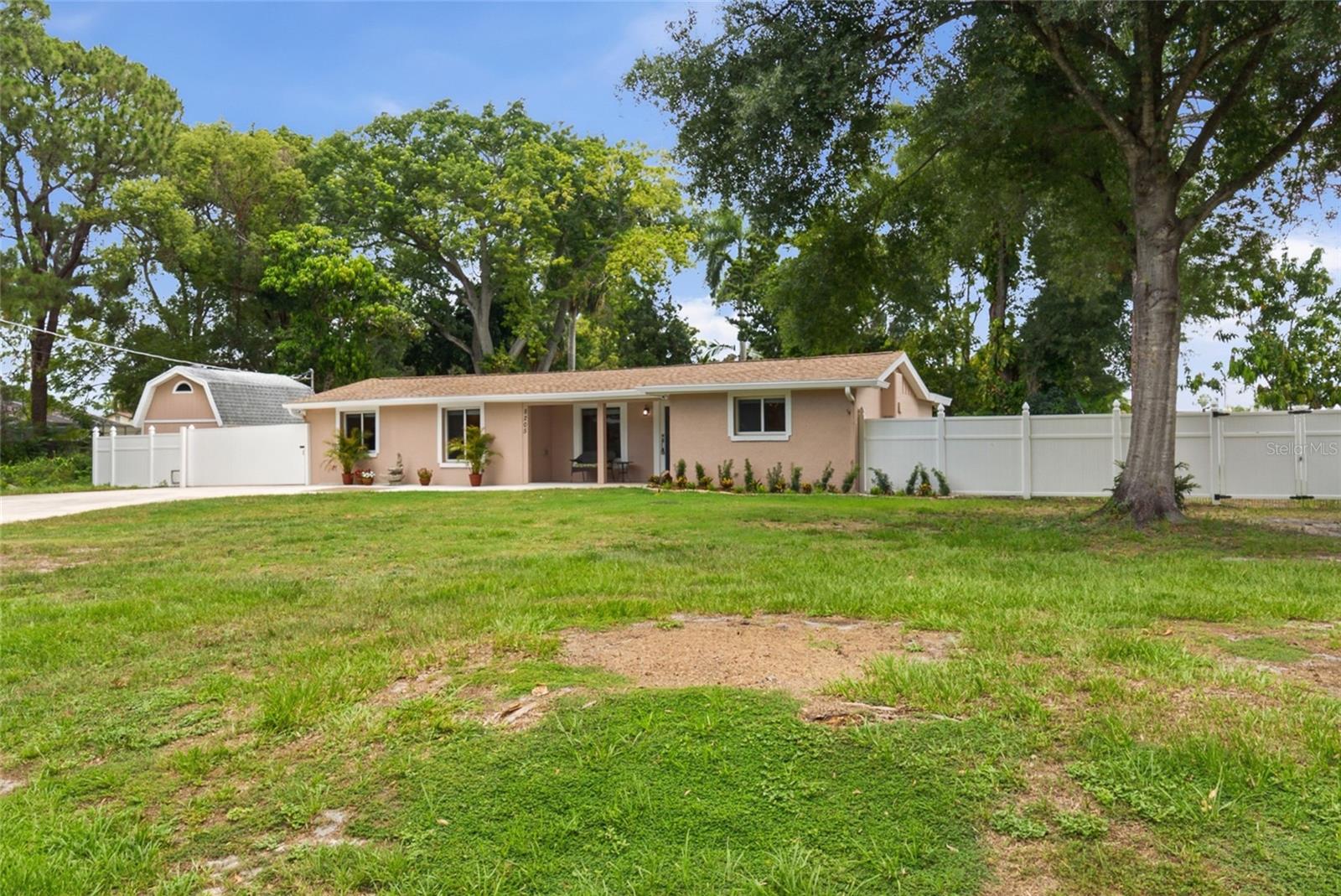 Welcome to this well maintained 3-bedroom, 2-bathroom Pool home nestled on an oversized 0.33-acre lot in the highly sought-after Pat Acres Estates neighborhood of Tampa's Town 'N' Country area. Offering a peaceful, country-style setting with no HOA or deed restrictions, this property provides the perfect blend of privacy, space, and convenience.  Step outside to your own backyard retreat featuring a propane-heated pool and jacuzzi, child safety fence, and a new vinyl privacy fence with a sliding gate for easy access. There's plenty of room to store a boat, RV, or recreational vehicle. Two storage buildings provide exceptional flexibility, including a barn-style shed complete with stairs and attic storage, plus an additional newer outdoor storage shed. Major updates provide peace of mind, including a new roof (2024), impact-rated windows and doors (2025), 4-ton A/C system (2021), tankless water heater (2019), well pump (2019), and pool pump (approximately 5 years old). The interior and exterior have also been recently painted.  Inside, you'll find 1,599 square feet of comfortable living space with stainless steel appliances, a gas range, washer and dryer included, and two bedrooms featuring spacious walk-in closets.  This move-in-ready property offers space, updates and flexibility.  Enjoy the best of both worlds—quiet residential living with easy access to everything Tampa Bay has to offer.  Conveniently located approximately 15 minutes to Tampa International Airport (7.7 miles), Raymond James Stadium, Benchmark International Arena, 25 minutes to University of South Florida, Busch Gardens, downtown Tampa and 35-40 minutes to Clearwater Beach. Nearby you have shopping - Publix, Walmart, Lowe's, numerous restaurants, banking, etc.