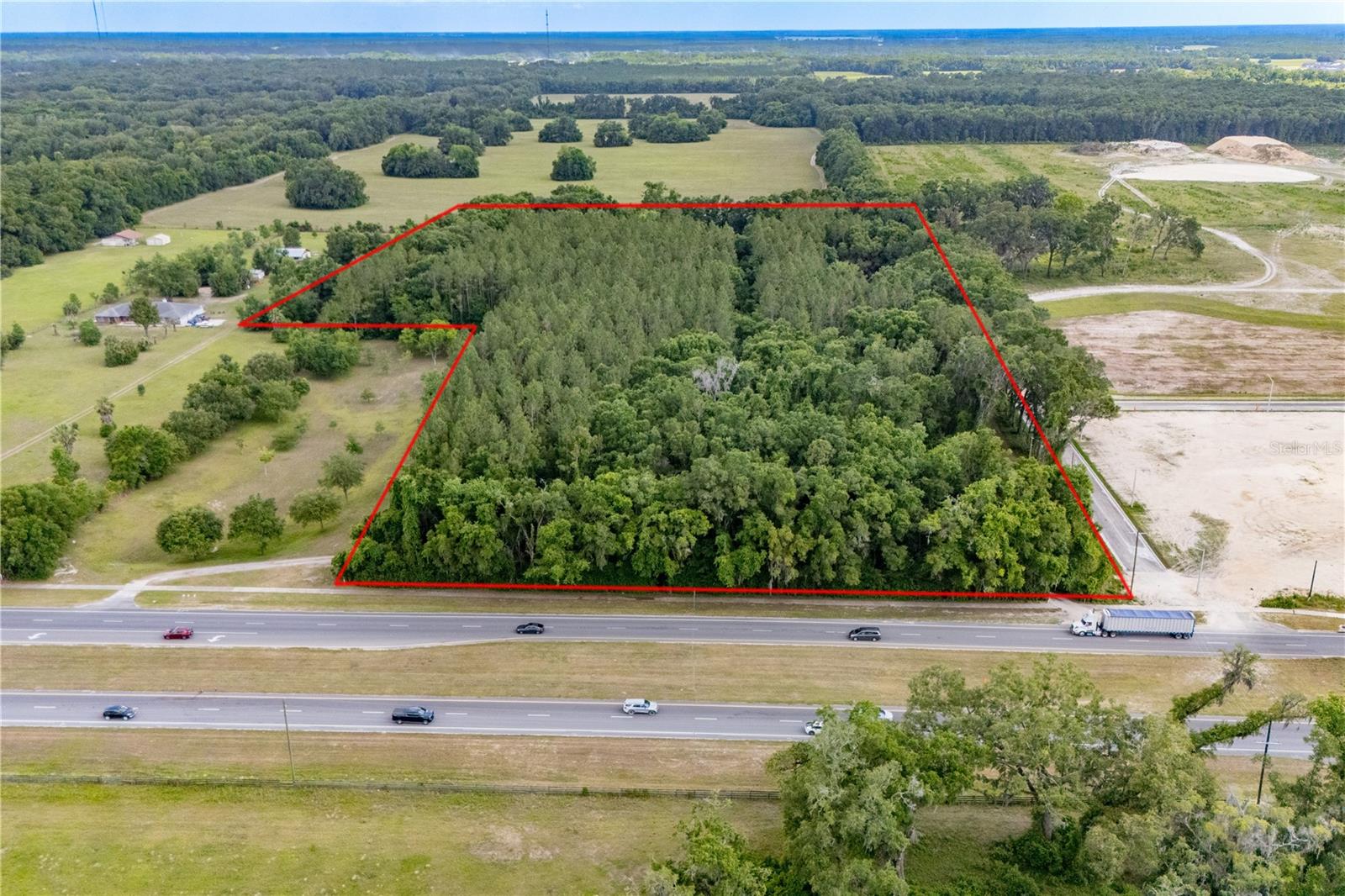 PRIME LOCATION!! 16.88 COMMERCIAL DEVELOPMENT OPPORTUNITY at the Gateway to Newberry. Approximately 460 Feet of Road Frontage on 4 lane-Newberry Road/State Road 26 Highway Frontage. City water and sewer hook up at corner of property. This Property is annexed into the City of Newberry. Perfect location for ER/Medical Facility/FSER, Apartments, restaurant, hotel, shopping center or any business needing easy access to Gainesville. Newberry is the NEW HOT SPOT of Alachua County. Excellent location & visibility. SR 26 is the main road of travel from numerous surrounding towns/cities. This property currently has 3 Homes and an Inground Pool. Newberry is west of Gainesville, 10 miles from I-75, 24 miles from the Gainesville Regional Airport, 15 miles to the University of Florida and is growing at a rapid pace. Across the street from the New Publix Shopping Center. The property on the west side that is butting up to this property is 128 acre of property being constructed as commercial & residential. This Parcel comes with City Utilities/Water, Waste Water and Electric hookup. Don't miss out on this Prime Property. When they say location, location, location, this is what they are talking about. This parcel lends itself to endless possibilities in an area where growth and development is on the rise. The two parcels which make up the 16.88 acres are: (01928-001-000 & 01928-001-002) Pines on Property will be harvested by the sellers before closing of the property. It is Buyers responsibility to confirm Zoning.