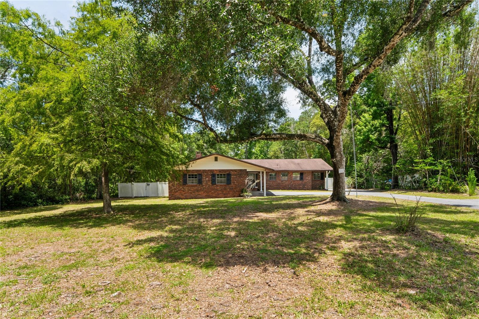 This 2,092 sq ft, 3 bedroom 2 ½ bath home built in 1970 could use some updating although it is completely ready for the new homeowner that isn’t afraid of some projects, or for an investor. 
Upon entry there is a coat closet on the right and a lodge style den with a wood burning fireplace is a nice feature for a “man cave” or a den/library. The main living room is connected to an informal dining area just off the kitchen. Continuing down the hallway, there is a bathroom with a tub/shower and glass doors. The first bedroom is perfectly sized for flex space of your choice. The Second bedroom has ample for a queen-sized bed, and at the end of the hallway, the primary has a small closet as well as a walk-in closet and a makeup desk just outside the primary bath. 
The Sitting on a 51,806 sq ft lot, this above ground pool home with a composite deck is ready for you to enjoy the outdoors with mature trees, the yard has 2 outbuildings for storage or a shop area yet offers plenty of room for toys, nature watching and still be close to shopping and the necessities. The property is in FEMA flood zone X, indicating minimal flood risk. Enjoy the best of both worlds—approximately 1.2 acres of privacy and space, while being just minutes from the charm, dining, shopping, and community events of historic downtown Brooksville and approximately one hour from Tampa and Tampa International Airport, and about 90 minutes from Walt Disney World, offering easy access to major employment centers, entertainment, shopping, dining, and Florida's world-famous attractions.