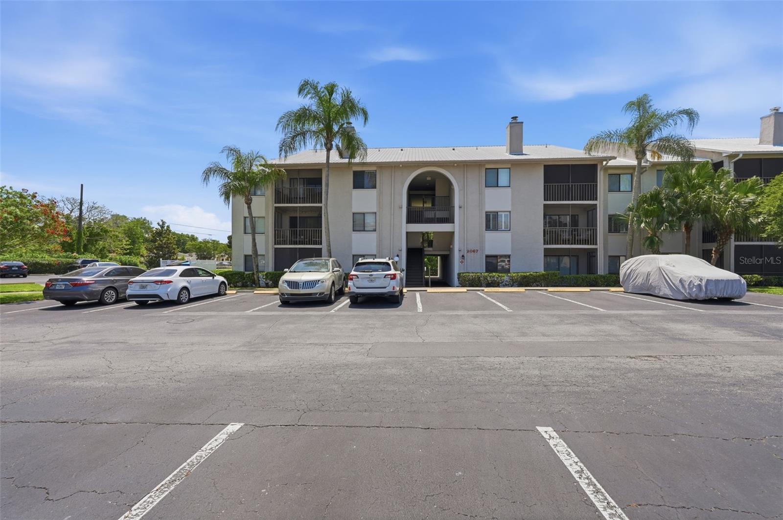 This bright and inviting 3rd-floor corner condo in coveted Dunedin offers the perfect blend of comfort, privacy, and convenience. 2-Bedrooms 2-Bathrooms Freshly painted and truly move-in ready, Step inside to find an abundance of natural light, ceramic tile floors, and soaring vaulted ceilings that enhance the open, airy feel. The thoughtfully designed split-bedroom floor plan provides added privacy, with bedrooms and bathrooms on opposite sides of the unit. Home features an open-concept layout with a spacious kitchen and breakfast counter, perfect for casual dining and entertaining. The living area is anchored by a cozy wood-burning fireplace and flows seamlessly to a large screened-in porch overlooking lush landscaping. Serene, tranquil, private, and quiet—this outdoor space is ideal for morning coffee or unwinding at the end of the day. The primary suite is filled with natural light and includes both a walk-in closet and an additional standard closet. The adjacent bathroom boasts a beautiful walk-in shower with luxurious glass doors. The second bedroom also offers a large walk-in closet and easy access to a full bath with a tub/shower combination. Additional conveniences include an in-unit washer and dryer and a generously sized storage room located just outside the front door. Out back, enjoy peaceful views of a pond filled with waterlilies and local wildlife. All of this just minutes from Downtown Dunedin, where you’ll find a vibrant mix of restaurants, unique shops, and lively atmosphere. This is one of the best values in the area—don’t miss your opportunity. Schedule your showing today!
