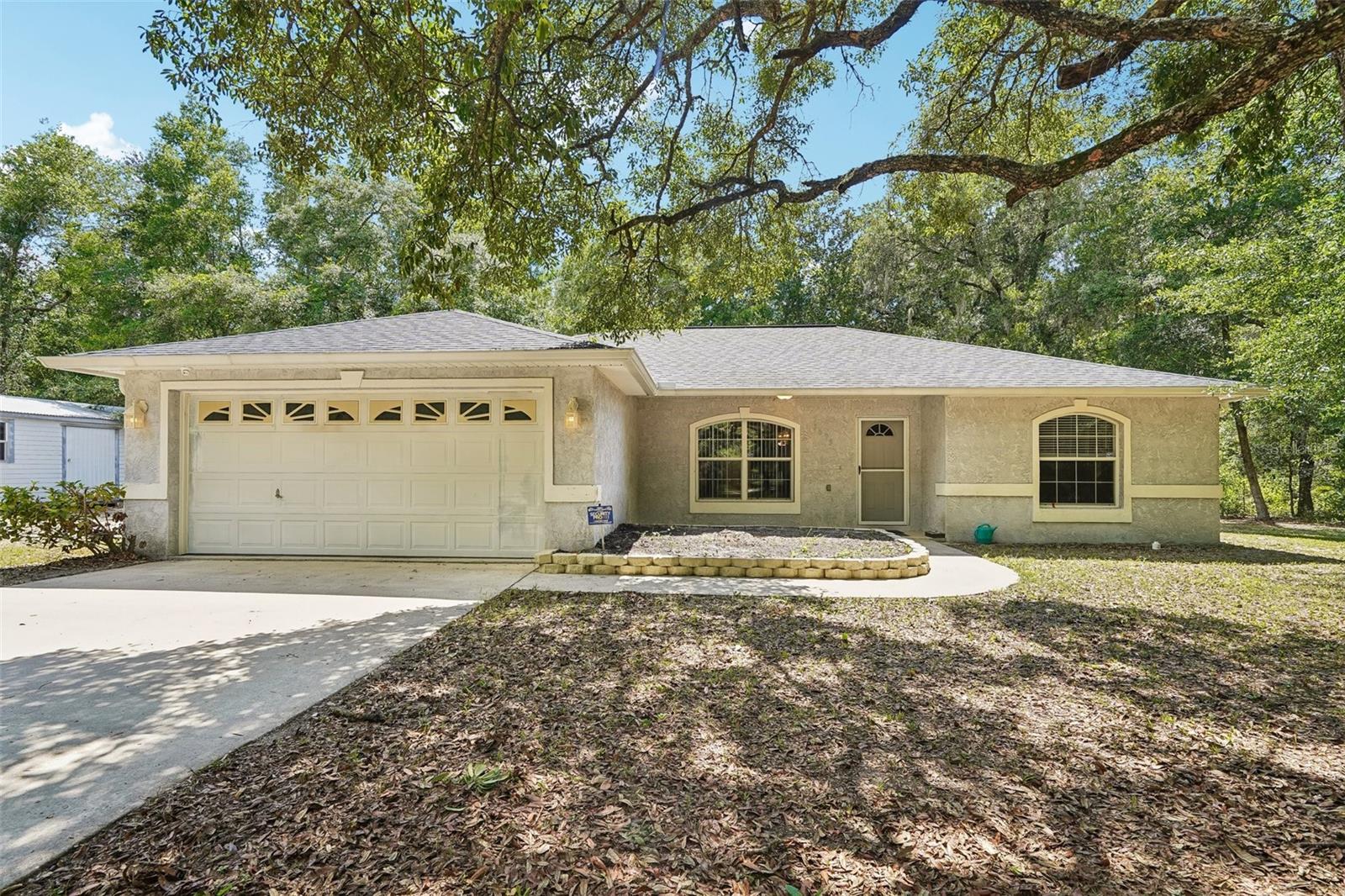 Welcome to your own private retreat in beautiful DeLand! Nestled on 2.5 wooded acres with NO HOA, this charming 3-bedroom, 2-bath home offers the perfect combination of privacy, space, and endless possibilities.

As you arrive, you'll immediately appreciate the peaceful setting surrounded by mature trees, creating a secluded oasis while still being conveniently located near shopping, dining, and major roadways. Whether you're looking for room to park your RV, boat, work trailers, or multiple vehicles, this property provides the freedom you've been searching for. A whole-house Generac generator adds even more functionality, providing dependable backup power for the home.

Step inside to an inviting open-concept layout where the living room, dining area, and kitchen flow seamlessly together, creating an ideal space for everyday living and entertaining. Large sliding glass doors lead to the covered, screened-in patio—the perfect place to enjoy your morning coffee, unwind after a long day, or watch the abundant Florida wildlife while overlooking your private wooded backyard.

The expansive acreage makes this property ideal for those with a family-owned business, outdoor enthusiasts, hobbyists, or anyone who simply desires extra space and privacy without the restrictions of an HOA. With plenty of room to expand, build a workshop, create gardens, or simply enjoy the serenity of nature, the opportunities are endless. 

If you've been dreaming of peaceful country-style living with the convenience of city amenities nearby, this rare DeLand property is one you won't want to miss. Schedule your private showing today and experience the freedom of 2.5 acres.