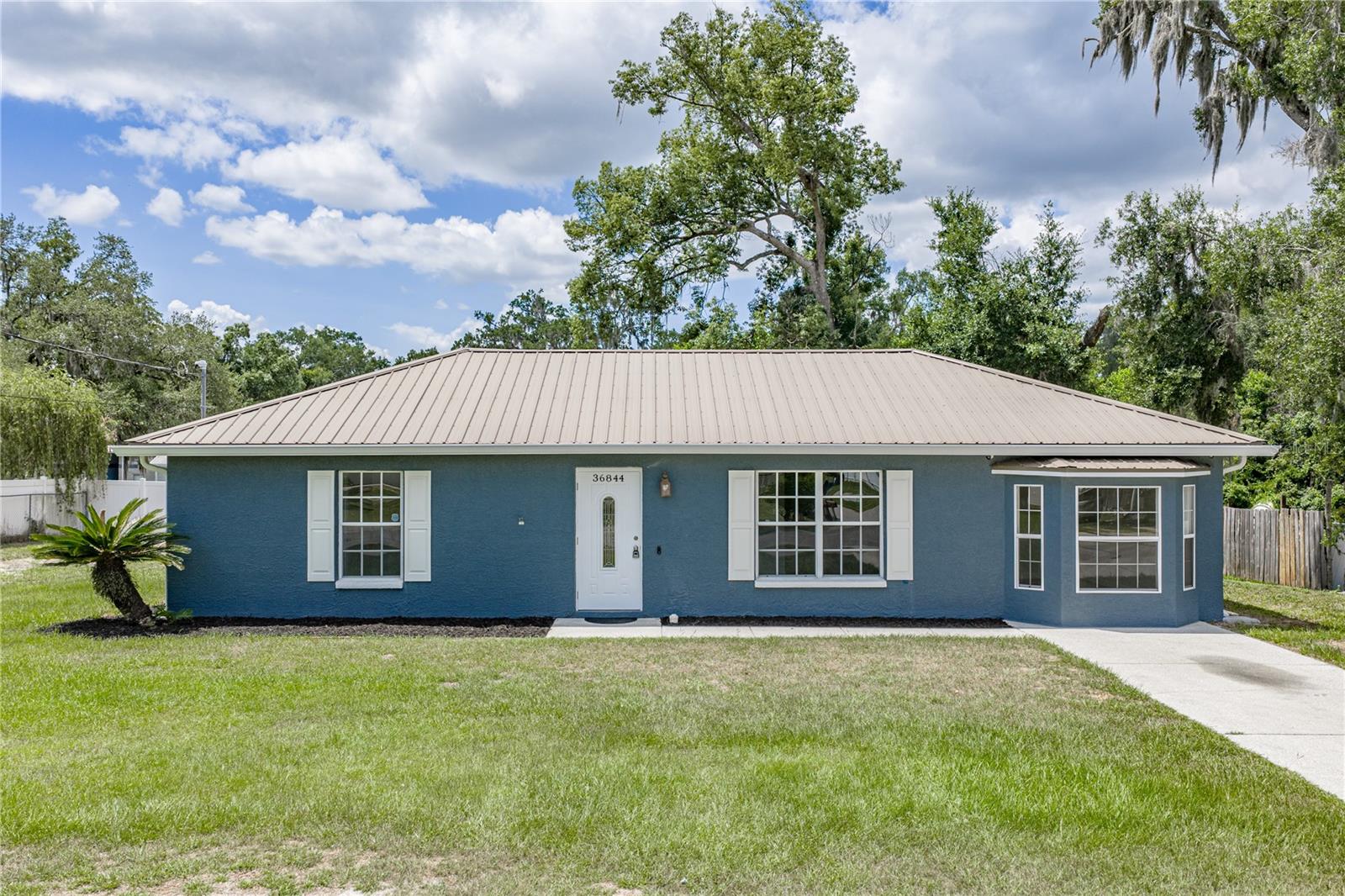 Beautifully refreshed 3-bedroom, 2-bath home just minutes from downtown Dade City! Inside, you'll find new flooring and fresh interior paint, giving the home a clean, updated feel. The layout offers a spacious living area, abundant natural light, and an easy flow into the kitchen and dining space, making it ideal for both everyday living and entertaining. The large backyard provides plenty of room to enjoy the outdoors, garden, or create your own private retreat. Located near the charm of downtown Dade City, you'll love being close to local car shows, parades, festivals, shops, and dining throughout the year. Whether you're looking for a primary residence or an investment opportunity, this move-in ready home combines comfort, convenience, and location.