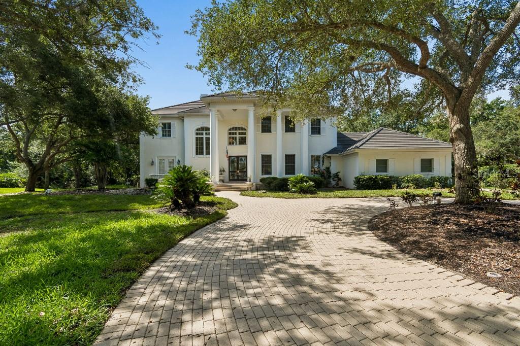 Welcome to 2984 Jeff Myers Circle, an extraordinary estate nestled within the elite Laurel Oak Estates of Sarasota. Situated on over an acre of beautifully landscaped grounds, this custom-built residence offers more than 5,000 square feet of refined living space, combining timeless elegance with modern comfort. The home features 5 spacious bedrooms, 4 full baths and 2 half baths, and multiple living and entertaining areas designed for both grand gatherings and everyday living.
From the moment you arrive, a sweeping driveway and impressive curb appeal set the stage for what awaits inside. Soaring ceilings, abundant natural light, rich architectural details, and expansive living spaces create an atmosphere of sophistication and warmth. The thoughtfully designed floor plan includes formal and casual living areas, a beautiful fireplace, generous bedroom suites, and seamless indoor-outdoor flow perfect for Florida living.
Step outside to your private backyard retreat, where mature landscaping and expansive outdoor living areas provide the perfect setting for entertaining, relaxing, or enjoying Sarasota’s year-round sunshine. Located within the gated Laurel Oak community, residents enjoy a serene setting surrounded by majestic oak trees, championship golf, tennis, and country club amenities, all while being just minutes from top-rated schools, shopping, dining, downtown Sarasota, and the world-renowned Gulf Coast beaches.
This is a rare opportunity to own a distinguished estate in one of Sarasota’s most sought-after luxury communities—where privacy, elegance, and an exceptional lifestyle come together.