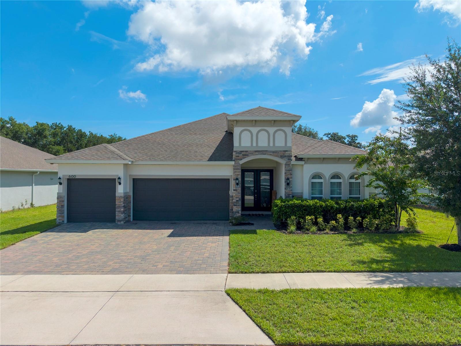 Built in 2022, this beautifully maintained 4 bedroom, 3 bathroom home in the sought after Talichet at Venezia community offers a modern layout with quality finishes and plenty of space to enjoy. The open concept design centers around a stylish kitchen featuring upgraded appliances, granite countertops, and a large island that overlooks the main living and dining areas, making it ideal for both everyday living and entertaining. The spacious primary suite includes a well appointed bath with a split dual vanity, relaxing garden tub, and separate shower. Step outside to a screened enclosed patio overlooking an oversized lot of more than a quarter acre, providing room to relax, play, or create your own backyard retreat. Located in the charming town of Howey in the Hills, this home offers the perfect blend of newer construction, functional design, and peaceful Florida living.