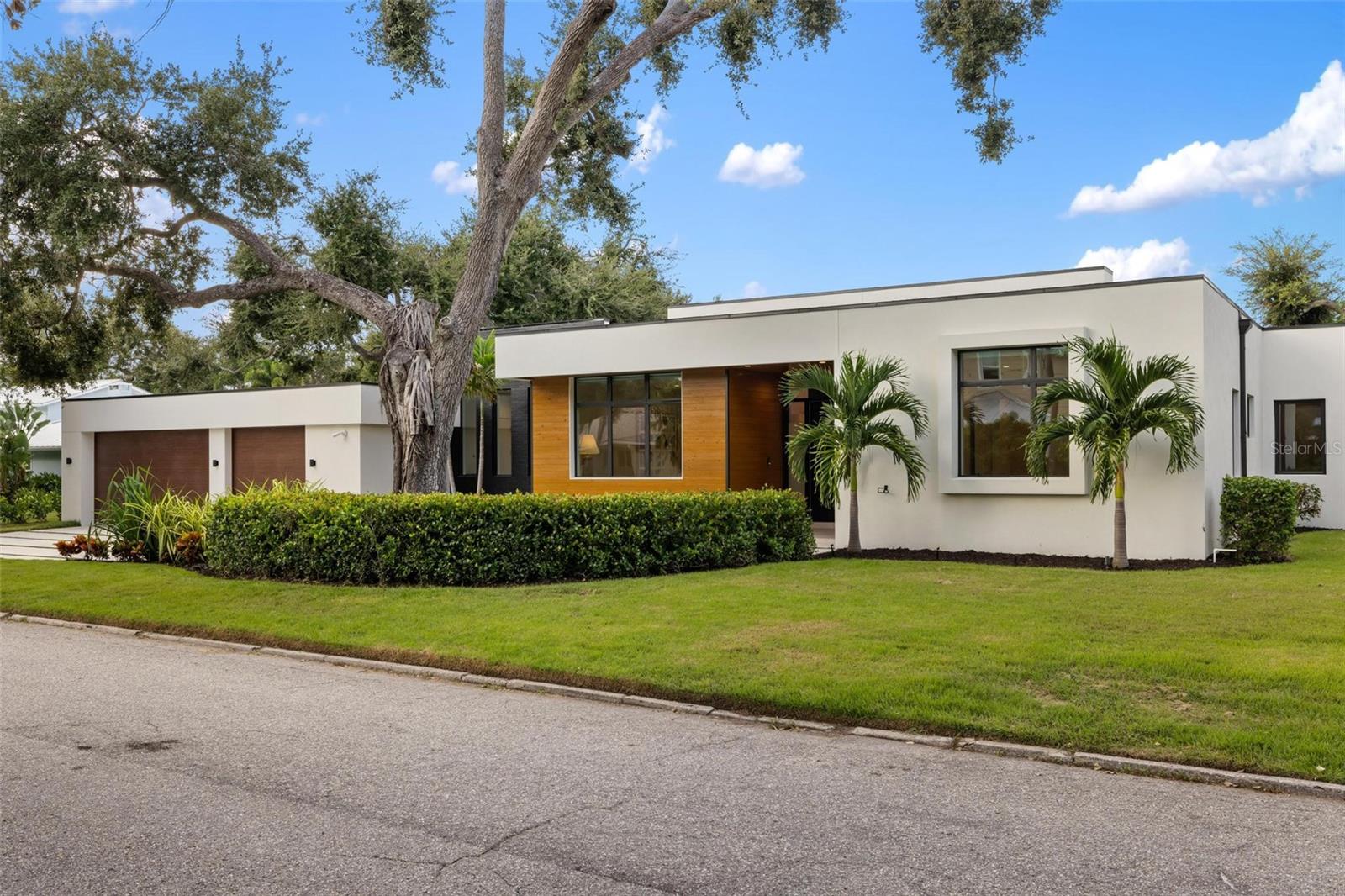 Introducing a rare opportunity in Poinsettia Park II, one of the most desirable enclaves within Sarasota’s coveted West of Trail community. Built in 2023 by Voigt Brothers, this single-level custom residence offers 4,550 square feet of elevated living on an oversized .38-acre lot, where timeless design meets modern innovation. From the moment you enter, soaring ceilings and a flawless Stage 5 drywall finish set the tone for elevated craftsmanship and intentional design. At the heart of the home, a bright and expansive open-concept living area is anchored by a chef’s kitchen featuring Bosch refrigerator and freezer towers, a gas range with pot filler, electronic upper cabinetry, and a striking leather-finished quartzite island. The primary suite offers a private retreat with two spacious walk-in closets, an oversized soaking tub, custom indoor shower, outdoor shower, and a tranquil courtyard. Four additional bedrooms—including a distinctive guest wing with wet bar, wine cooler, and lounge area—provide both flexibility and privacy for residents and guests alike. Luxury finishes continue throughout, including 8-ft solid core doors, custom closet systems, and an electric fireplace in both the living room and primary suite. Smart home technology integrates seamlessly with electronic window treatments, audio and lighting controls, and a whole-home security system. Designed for indoor-outdoor living, the great room opens to a resort-style backyard featuring a covered entertaining area, Blaze outdoor kitchen with gas grill, saltwater heated pool, and two outdoor showers—all wrapped in privacy fencing and enhanced by architectural hardscaping and a full irrigation system. Ideally located near top-rated Southside Elementary, Sarasota Memorial Hospital, and the boutique shopping and dining of Southside Village and downtown Sarasota, with world-renowned Siesta Key, Lido Key, and St. Armands Circle just minutes away. This is more than a residence—it's a Sarasota lifestyle statement.
